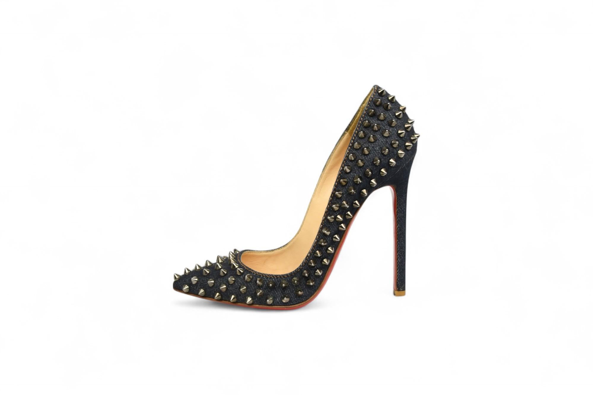 Unleash your inner rebel with these Christian Louboutin Pigalle Spikes pumps, crafted in deep indigo denim and punctuated by gleaming gunmetal spikes. A daring twist on a classic silhouette, these pointed-toe stilettos feature the label’s signature