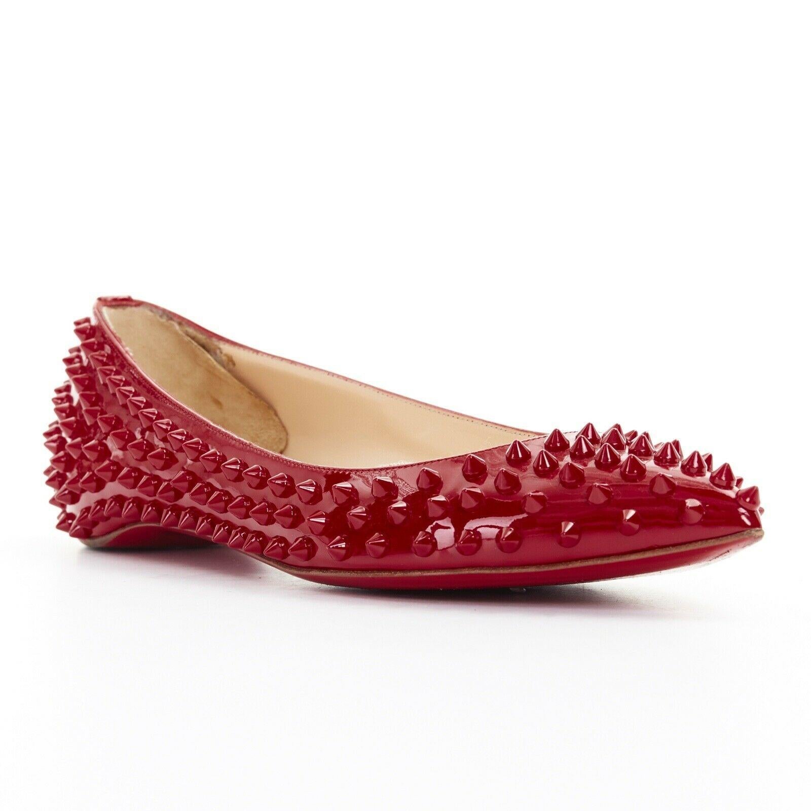 CHRISTIAN LOUBOUTIN Pigalle Spikes red patent studded pointy flats EU38.5
CHRISTIAN LOUBOUTINPigalle Spikes. 
Red patent leather with tonal spike stud allover embellishment. 
Pointed toe. Slip on. Padded tan leather lining. 
Signature red lacquered
