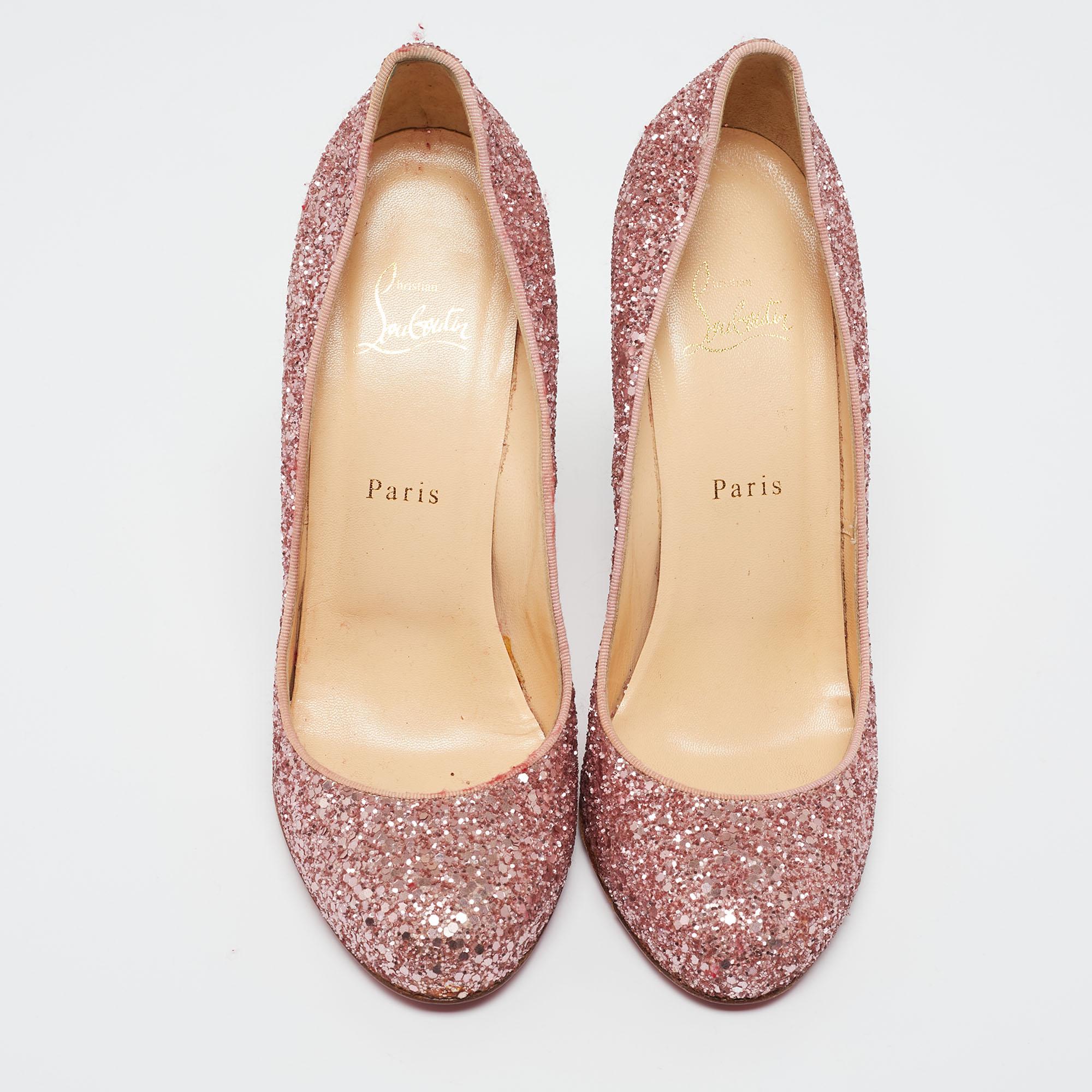 Feel glamorous every time you slip into this glitzy pair by Christian Louboutin. Covered in pink glitter and balanced on 13 cm heels, these pumps will be a winner with all your well-tailored outfits. They are finished with the signature red on the