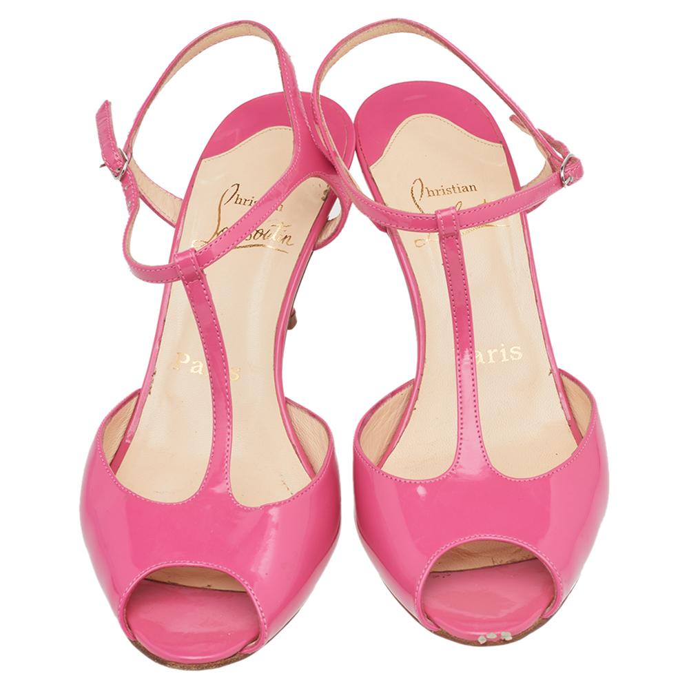 This pair of Louboutins is on the wish list of every fashionista. Styled in patent leather, these pink sandals come with a 'J' string T-strap vamp design, peep toes, and 7.5 cm heels. The iconic red soles make this pair instantly recognizable. Pair