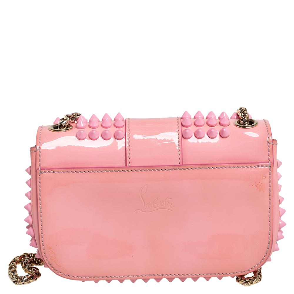 Made from patent leather, this Sweet Charity bag is a glamorous accessory. With this chic bag from Christian Louboutin, carrying your essentials need not be mundane anymore. A gorgeous pink shade and the signature spike embellishments characterize