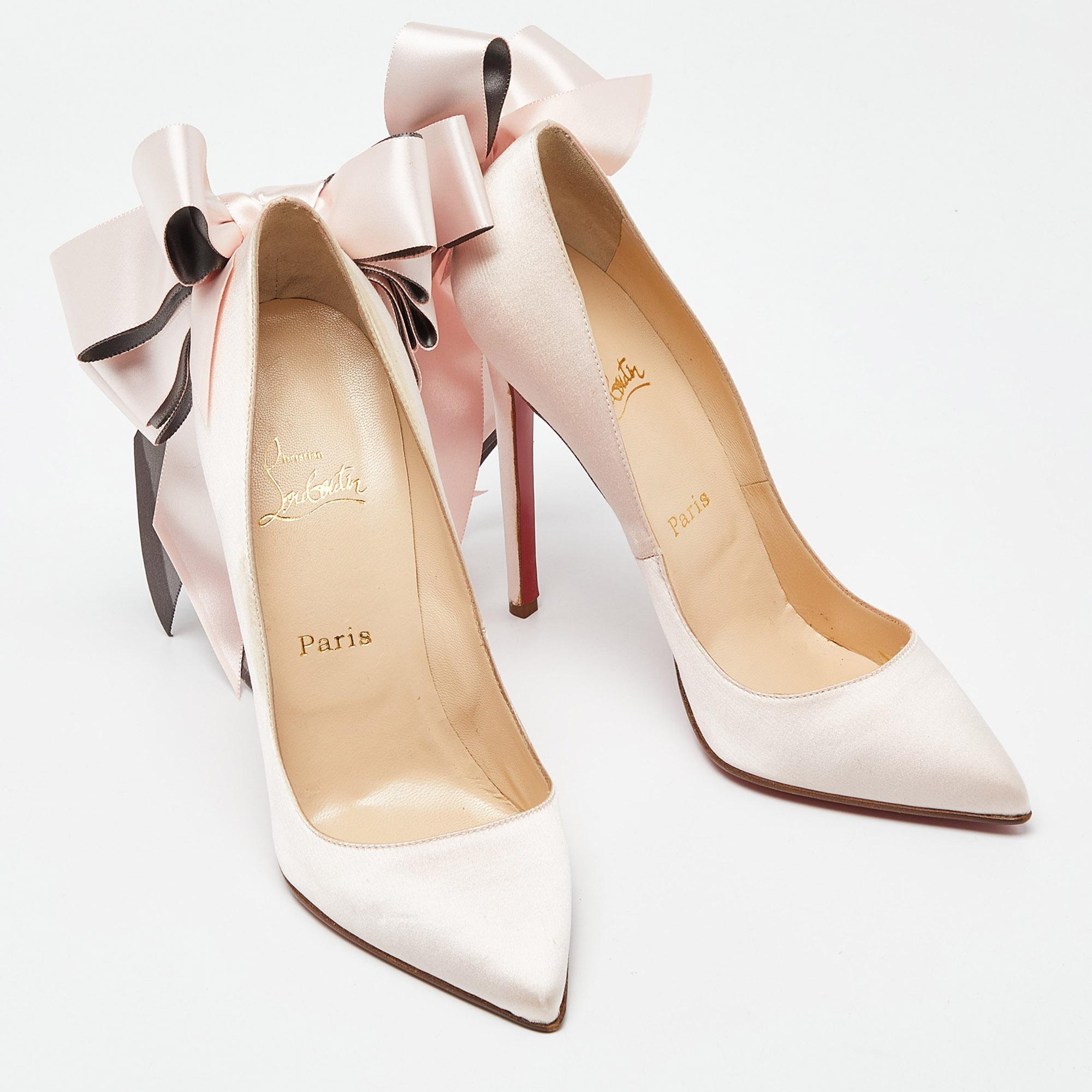 In delicate pink satin, the Christian Louboutin Anemone pumps exude femininity. The sleek silhouette is accentuated by a graceful bow detail, adding a touch of charm. With a classic pointed toe and a slender stiletto heel, these pumps effortlessly