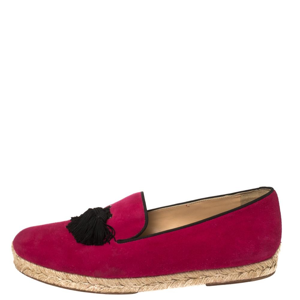Let this comfortable pair of loafers by Christian Louboutin be your first choice when you're out for a long day. The shoes are covered in suede and styled with tassels on the uppers. Signature red soles beautifully complete the women's loafers 