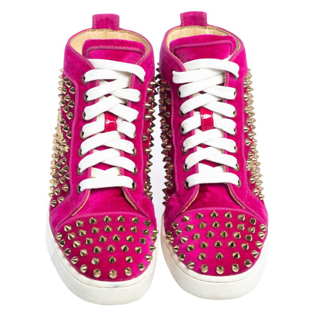 Crafted from velvet into a mid-top silhouette, these Christian Louboutin sneakers signify the label's craftsmanship in shoemaking. They are detailed with spikes all over and laces on the vamps.

