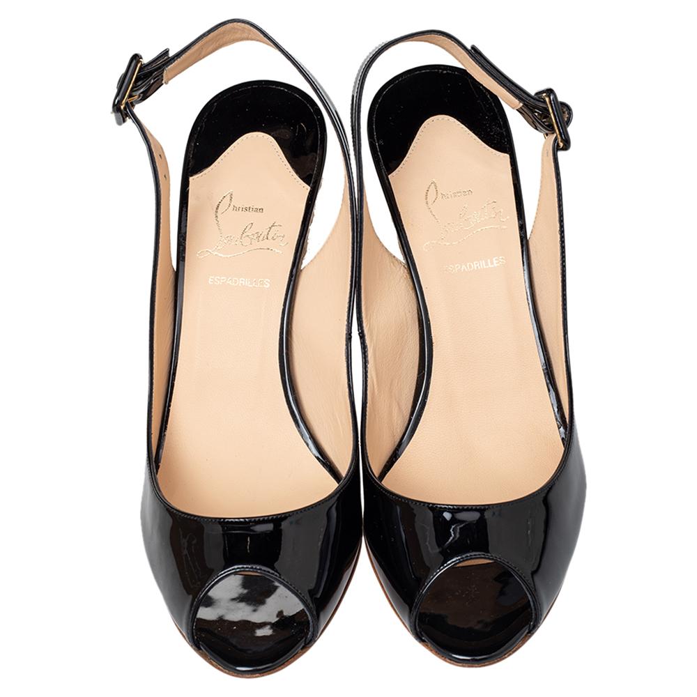 This beautiful pair of patent leather sandals will bring you a confident, comfortable walk. Set on espadrille wedges and red leather soles, these uber-stylish sandals are perfect for any season. The Christian Louboutin pair in black will be a prized