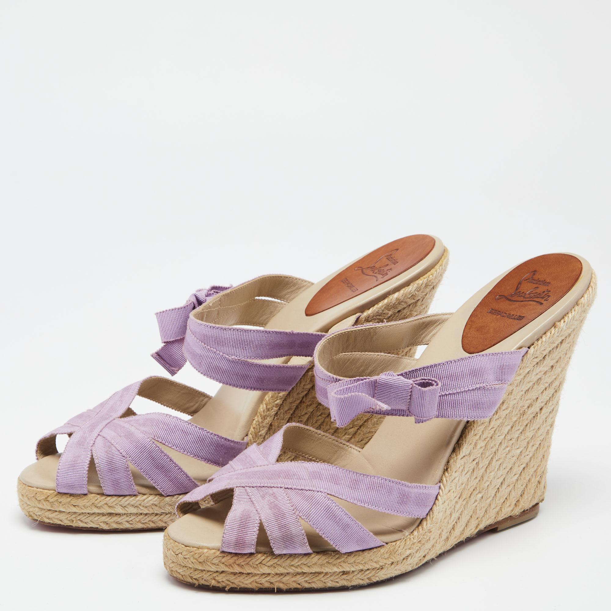Christian Louboutin brings a perfect pair for the summer season! These sandals come with a purple-hued strappy upper that will frame your feet in the most elegant way. The espadrille wedge heels are supported by platforms for the comfort of your