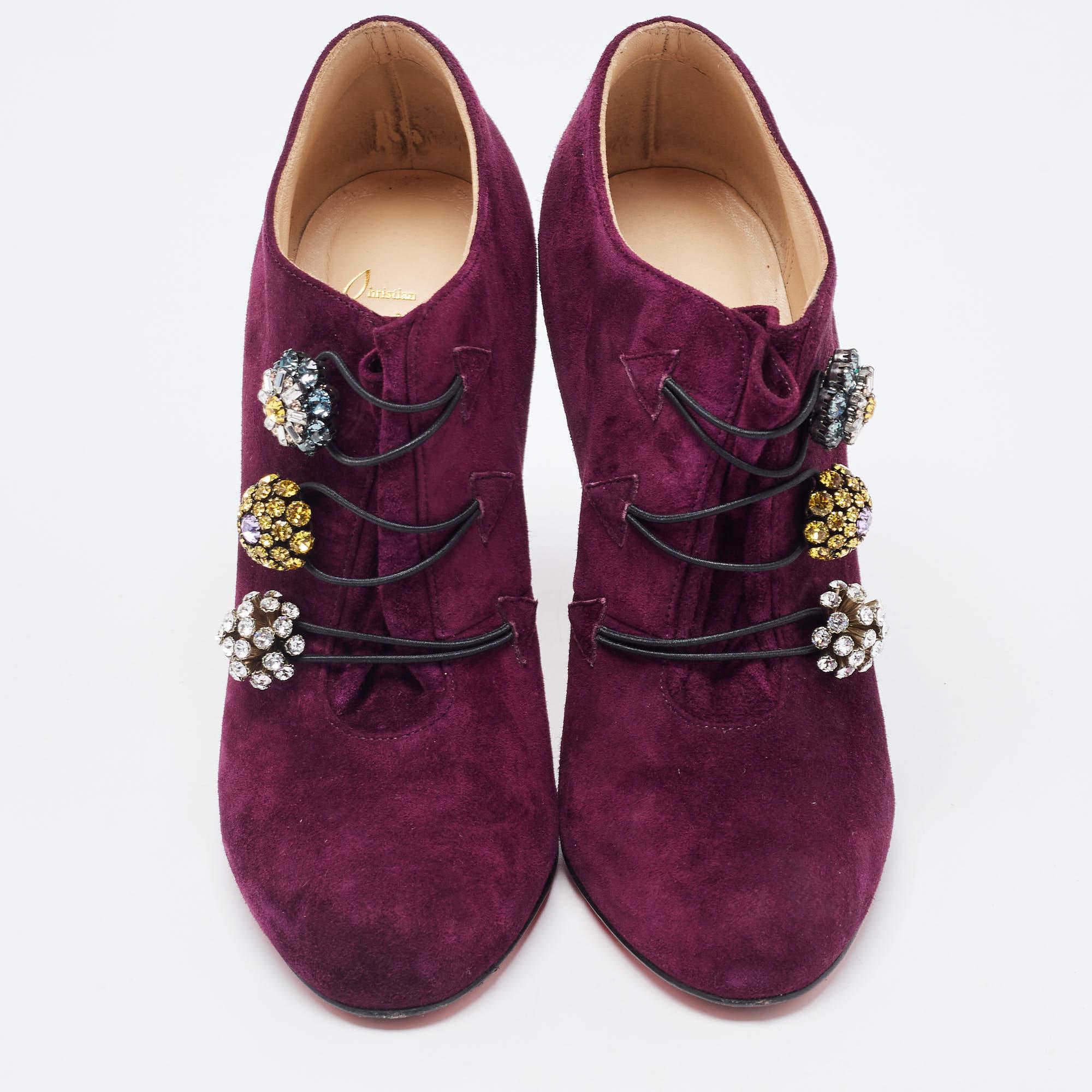 Fashionable and edgy, Christian Louboutin’s booties are crafted in purple suede. These round-toe booties feature striking motifs on the upper and are elevated on 11cm heels. They are finished with the signature red soles.

Includes
Original Box, The