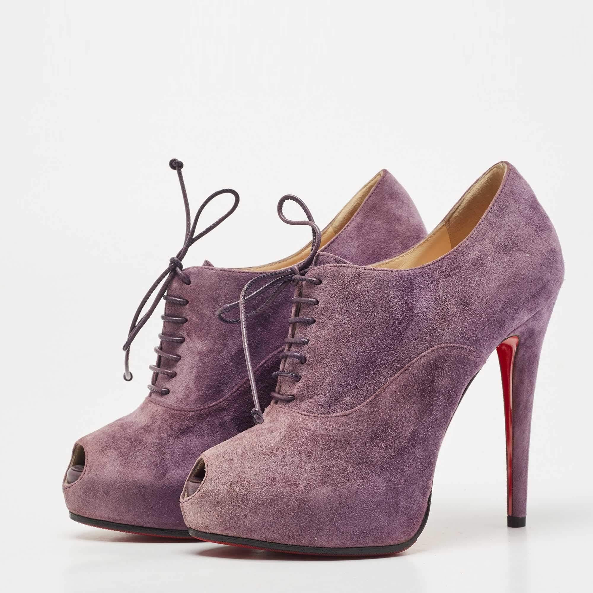 Made from high-quality purple suede, they feature a peep-toe design and lace-up detailing. With their sleek silhouette and signature red sole, these Christian Louboutin booties add a touch of luxury and sophistication to any outfit.

