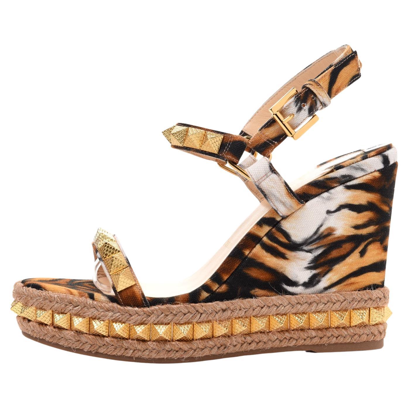 Dotted with signature spiked embellishment and braided raffia trim, these platform wedges are finished with a dramatic tiger stripe design. Cotton upper. Open toe. Adjustable ankle strap. Wedge heel 110mm. Brand new, never worn. Comes in all the