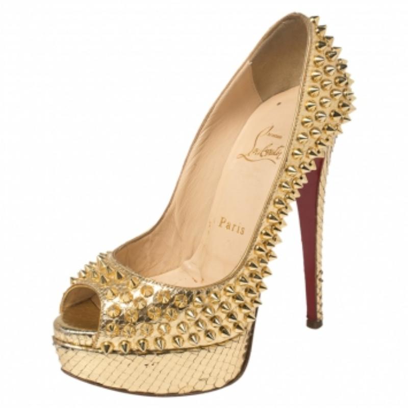 Bring home this meticulously designed pair of Christian Louboutin platform pumps to nail stunning looks at all times! Crafted out of python leather, this gold creation is from the Lady Peep collection. The CL peep-toe pumps are elevated on platforms