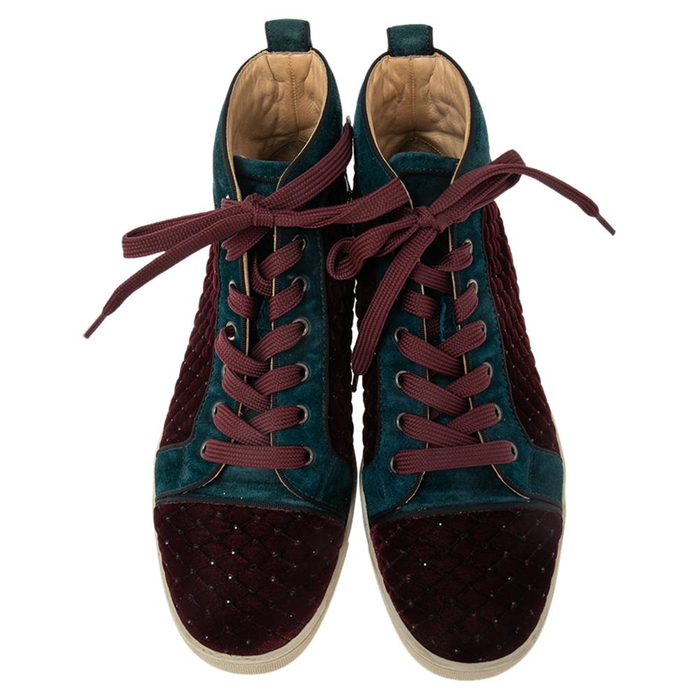 Pull off a stylish look with class in this pair of high-top Rantus Orlato sneakers from Christian Louboutin. Crafted from velvet and suede, the pair effortlessly embodies luxury and comfort. They feature simple lace-ups, leather insoles, and red