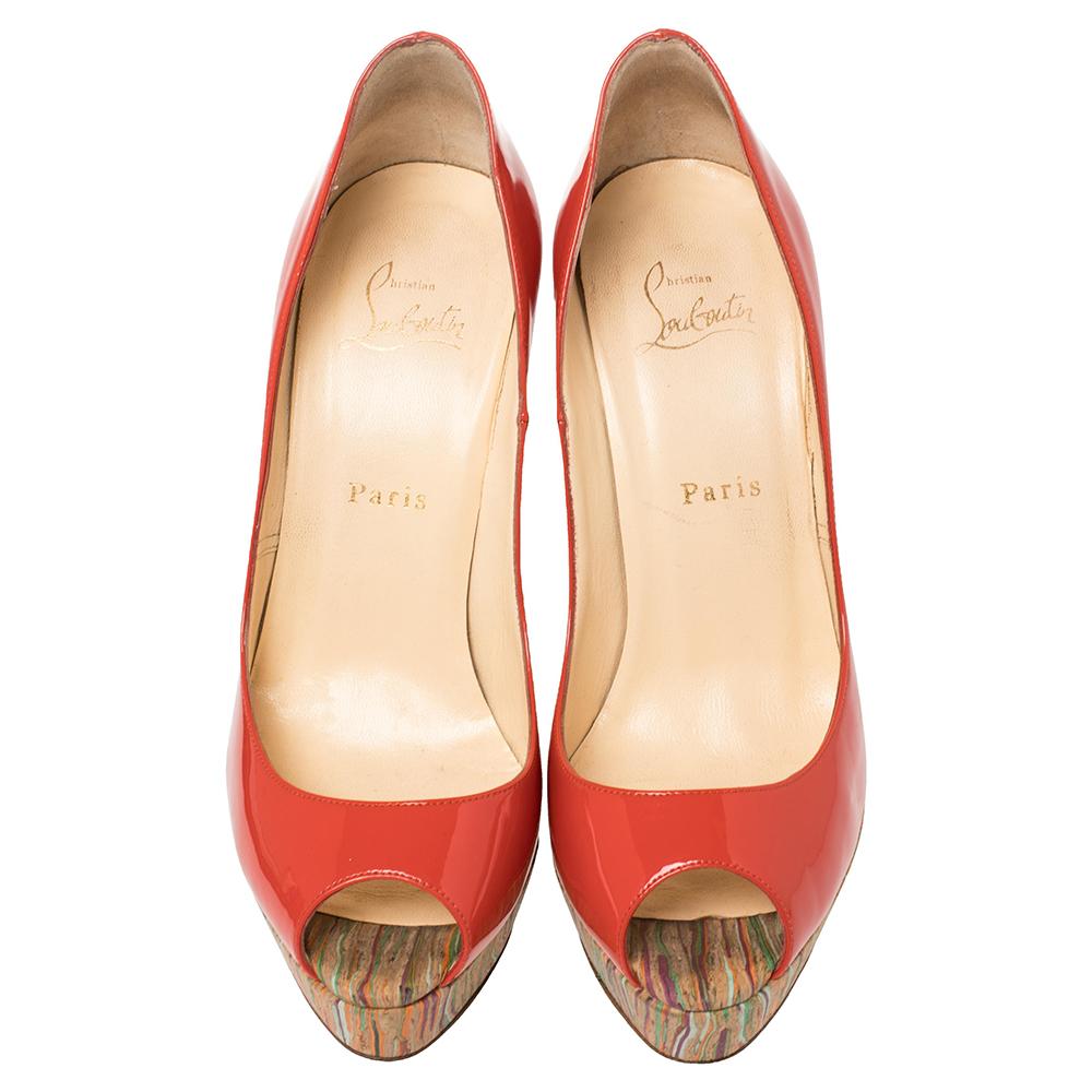 Stand out from a crowd with this gorgeous pair of Louboutins that exude high fashion with class! Crafted from patent leather and cork, this is a creation from their Lady Peep collection. The pumps feature a lovely brick red shade with peep toes and