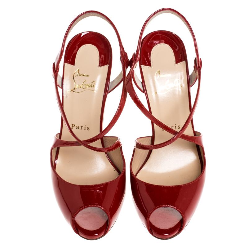 These sandals will make you look confident and uber-stylish. These strappy sandals are crafted in Italy and made from red patent leather. They feature open toes, crisscross straps, signature red soles and 12 cm heels. Flaunt your love for fashion
