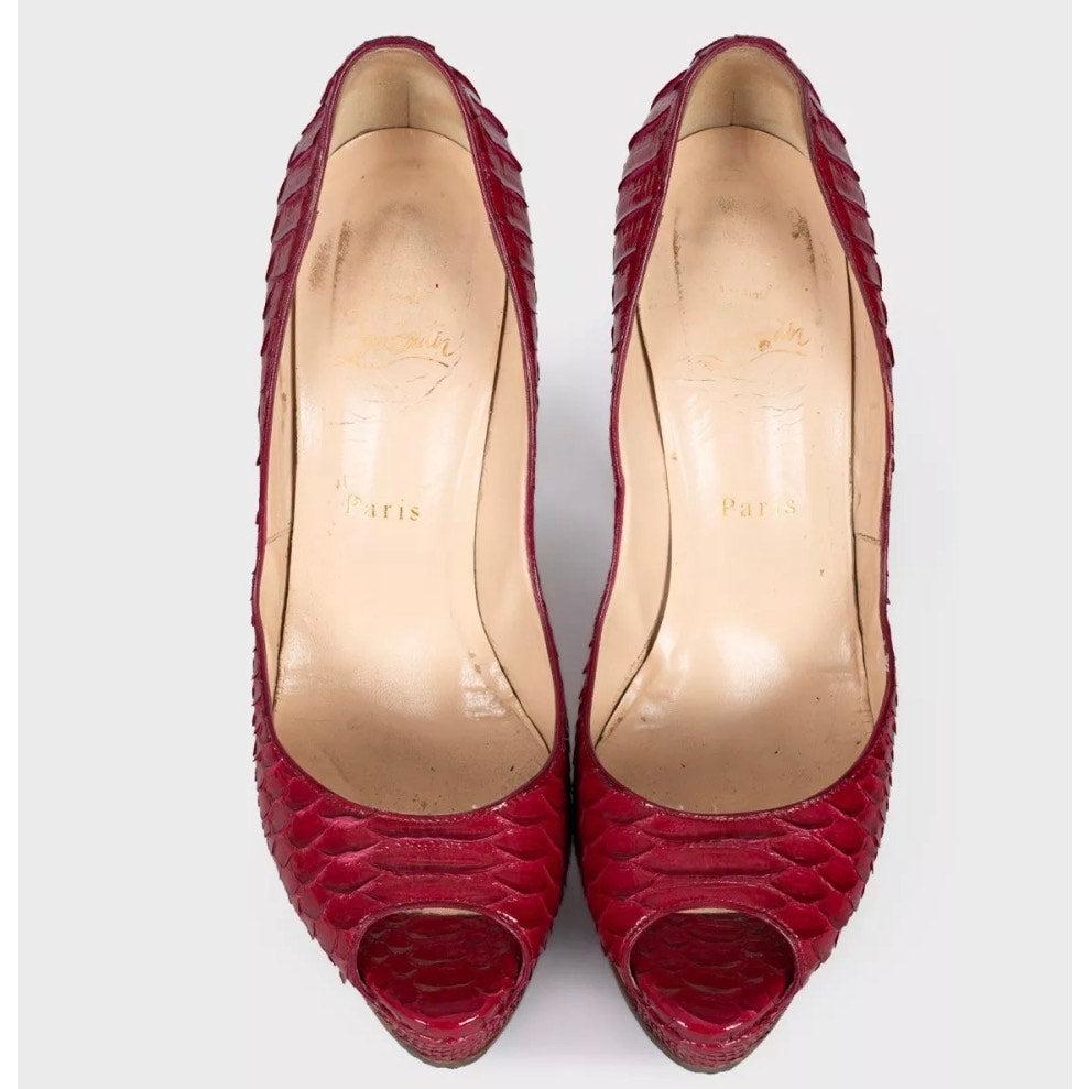 Elevate your style with these stunning Christian Louboutin peep-toe pumps! Crafted from genuine python leather in a vibrant red, these heels are sure to turn heads. The classic peep-toe silhouette and stiletto heel create a timeless and elegant