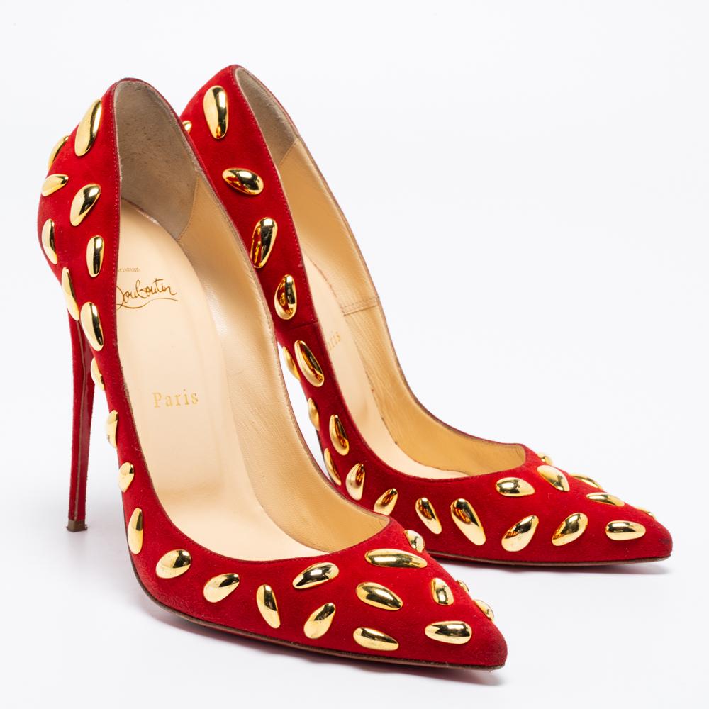 These Christian Louboutin pumps exude a refined style and sophisticated vibe with their design. Covered in red suede, they are highlighted by gold-tone embellishments all over the exterior. These beauties are finished off with stiletto heels and the