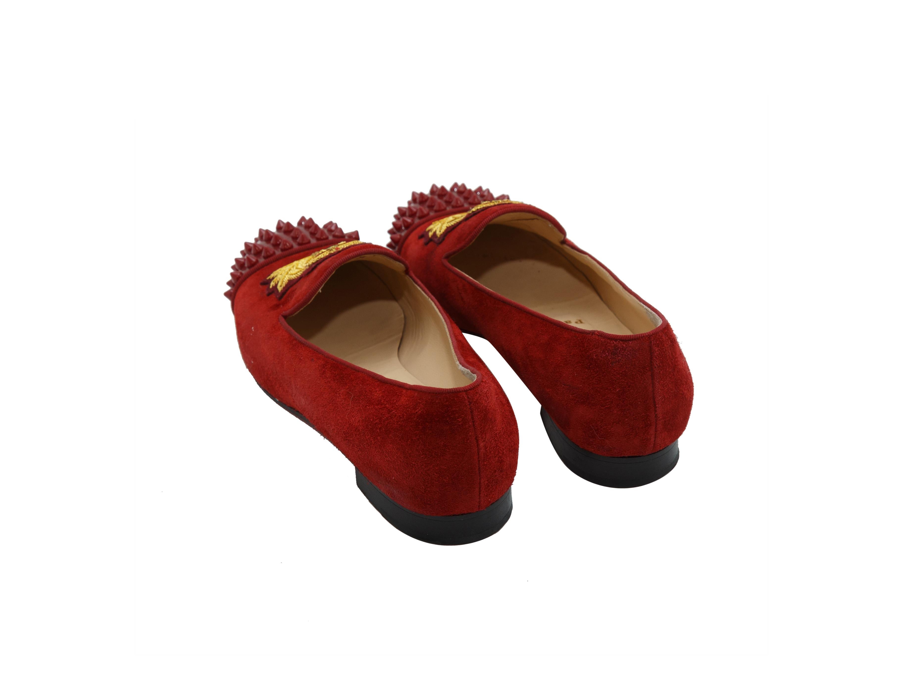 Product details: Red suede round-toe flats by Christian Louboutin. Slip-on style. 'CL' embroidery at tops. Stud embellishments at toes. Designer size 36. 0.5