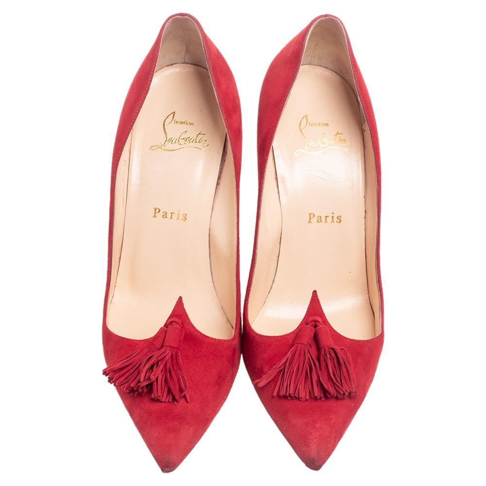 The House of Christian Louboutin excels at creating marvelous footwear that remains highly popular globally. These Gwalior pumps are designed using red suede with a matching tassel embellishment on the front. They are further enhanced with