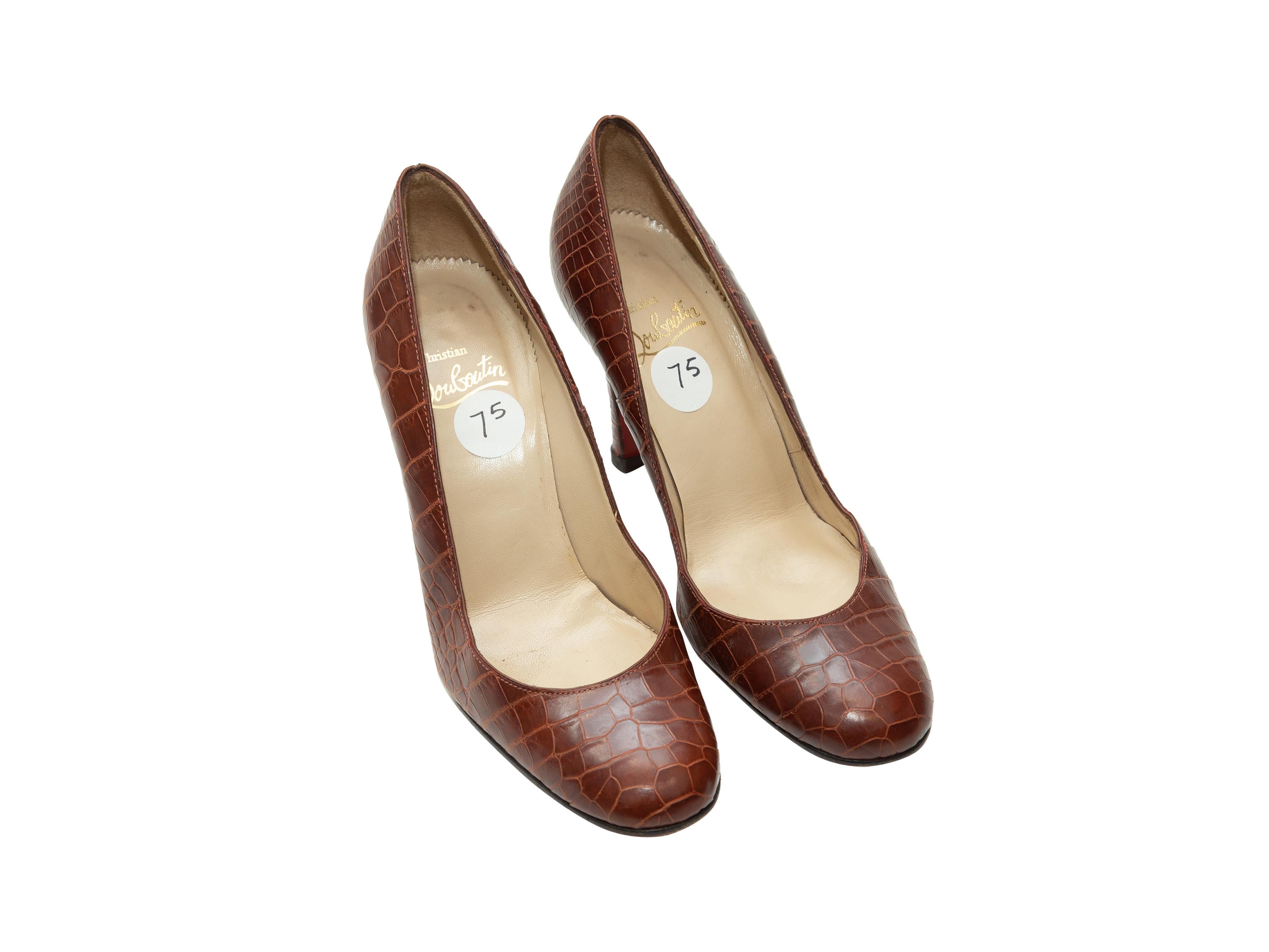 Product details: Rust red round-toe alligator heels by Christian Louboutin. Designer size 37.5. 3.5