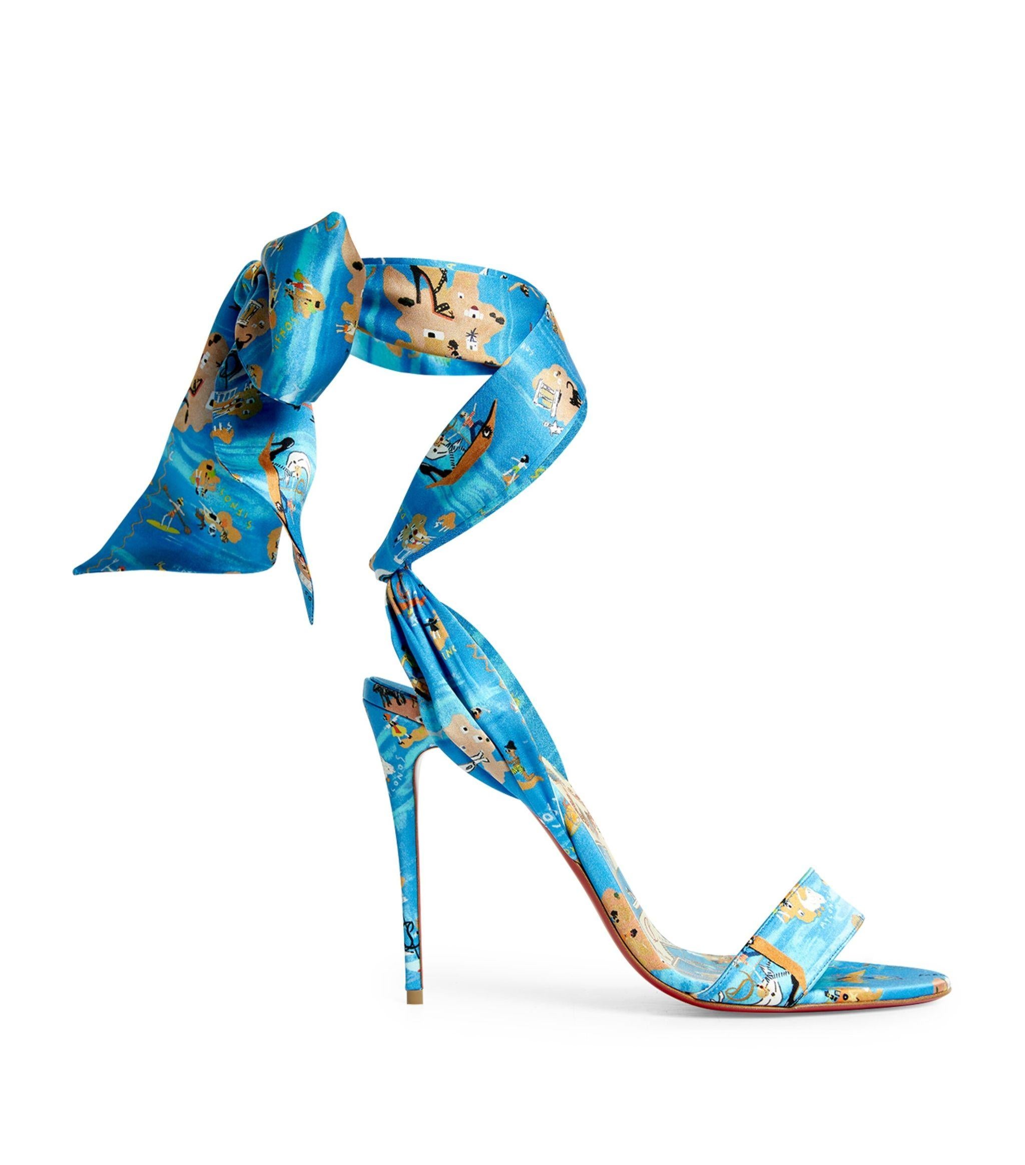 These chic stylish heels are crafted of Loubi Odyssey blue patterned crepe satin, inspired by the Greek islands. These have a 4-inch wrapped sharp stiletto, adjustable ribbon ankle ties and an open toe. Brand new, never worn. Comes in original