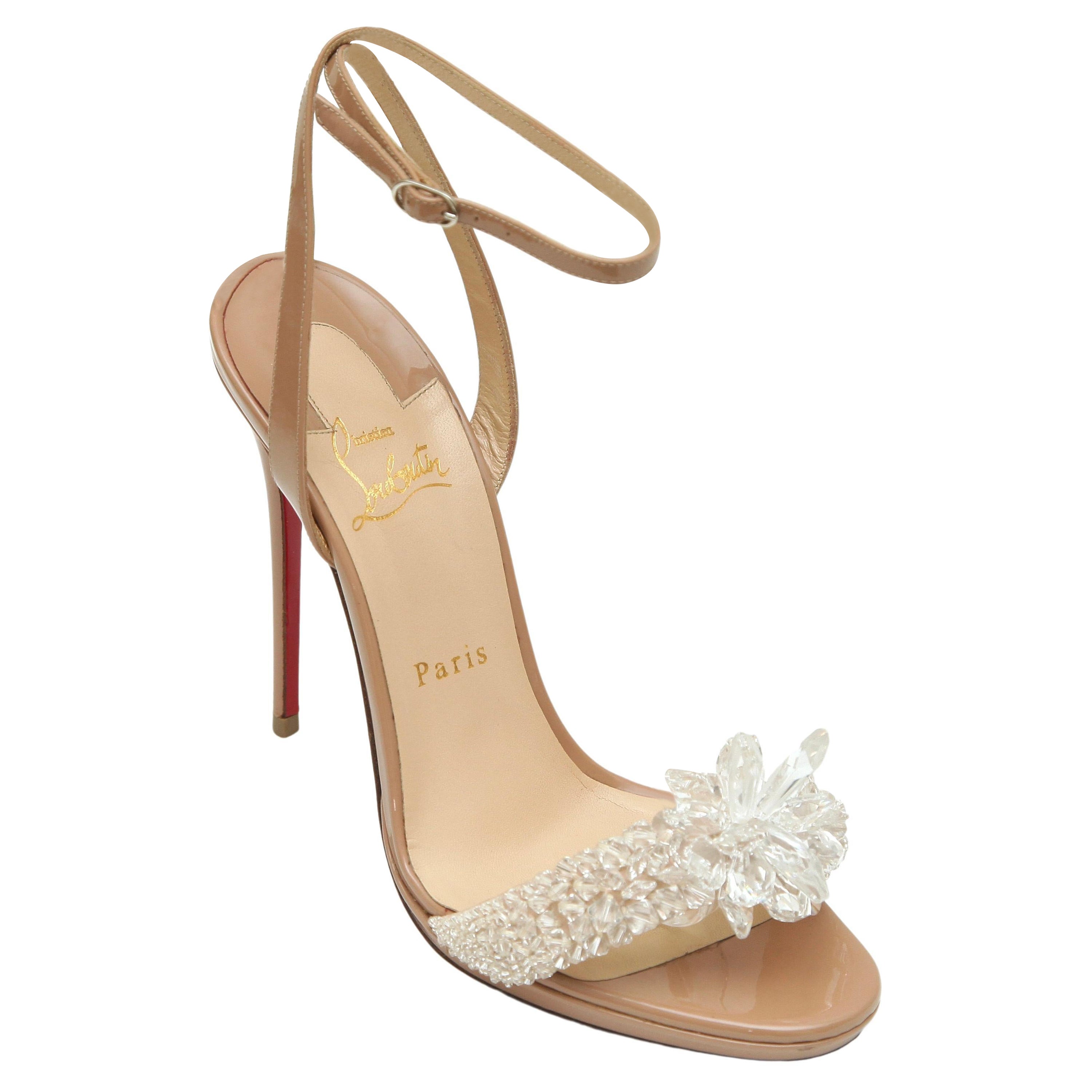 CHRISTIAN LOUBOUTIN CRYSTAL QUEEN EMBELLISHED SANDALS


Details:
- Patent leather in a nude-blush color.
- Embellished crystal strap over vamp.
- Almond toe.
- Ankle strap with buckle closure.
- Self covered heels.
- Leather lining and sole.
- Comes