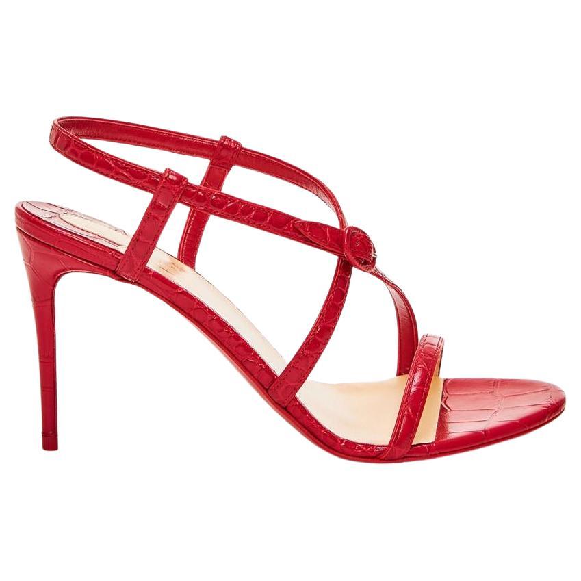 Red leather sandals from Christian Louboutin. The Selima sandals have a 85mm heel, an open toe and crisscross straps with a buckle closure around the ankle. Brand new, never worn. Comes in original packaging. Made in Italy.