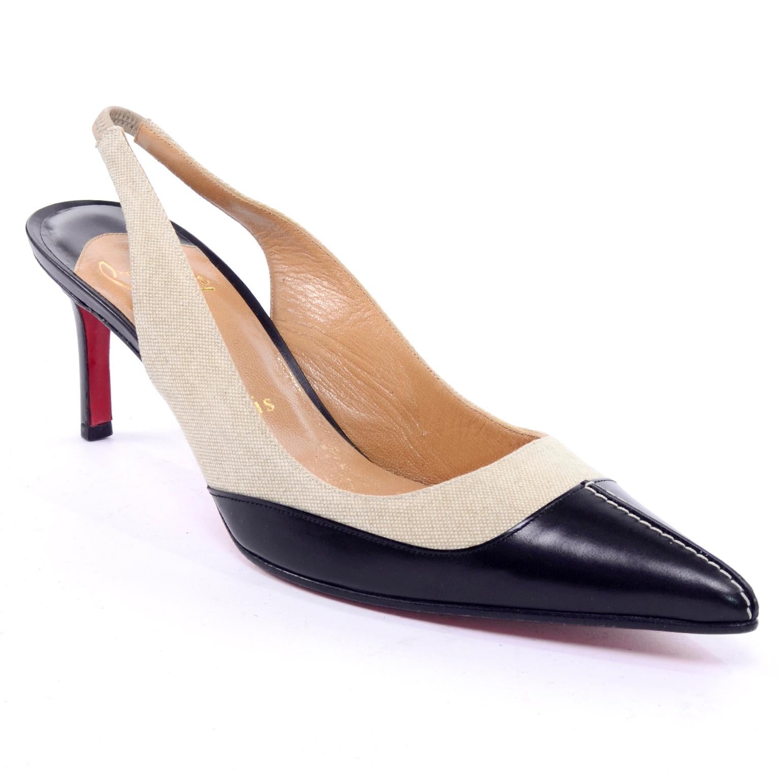 These are classic sling back shoes from Christian Louboutin with black leather and natural canvas.  The shoes have the red soles and there is topstitching on the toes.  Marked a size 38.5 which converts to a US size 8.5 or a UK size 5.5.  These