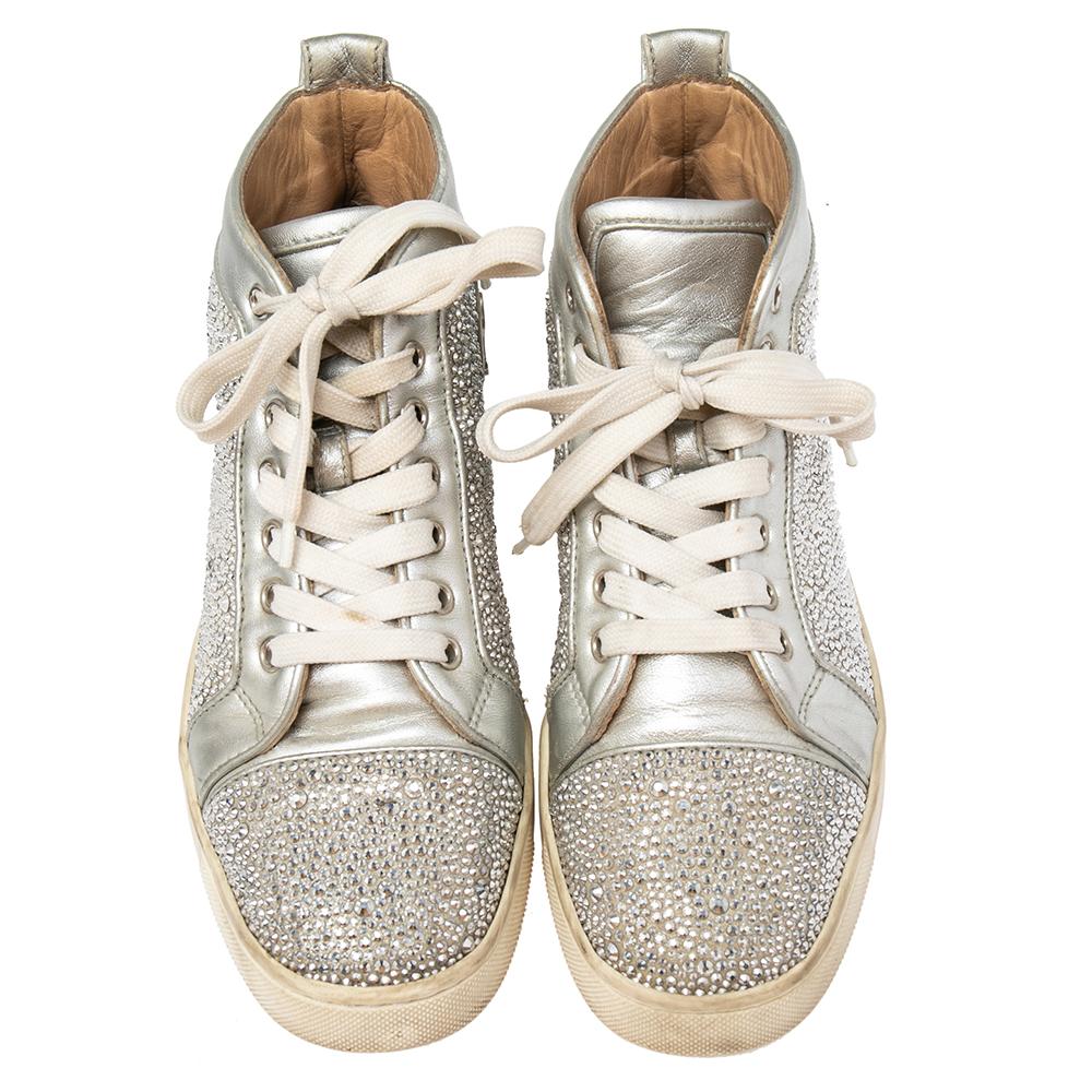 These Christian Louboutin's Louis sneakers are designed in a silver leather body with crystal detail all over for a dazzling look. Set on a rubber sole, this pair features lace-ups and comfortable insoles making it easy to slip in and out. Wear with