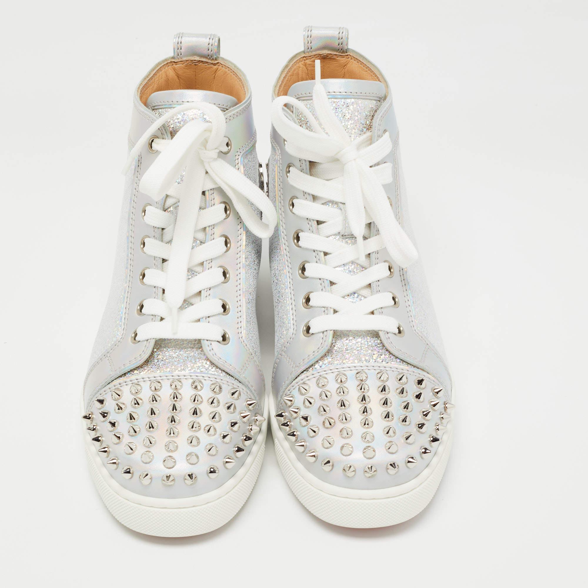 The addition of spikes makes these Christian Louboutin sneakers undeniably chic and striking. They are created from silver laminated suede and leather with lace-up vamps, pull-tab at the counters, and comfortable soles.

Includes: Original Dustbag,