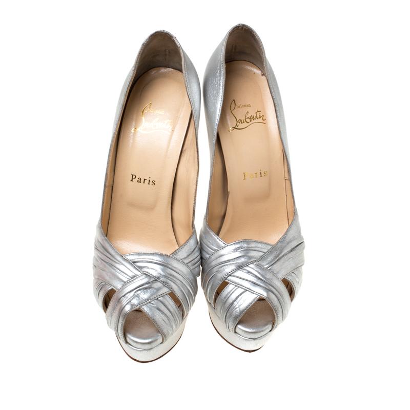 These classic pumps from the house of Christian Louboutin is that versatile pair that you can wear with many of your outfits. It features a silver leather body with crisscross straps on the front, set on a low platform sole and comes with a