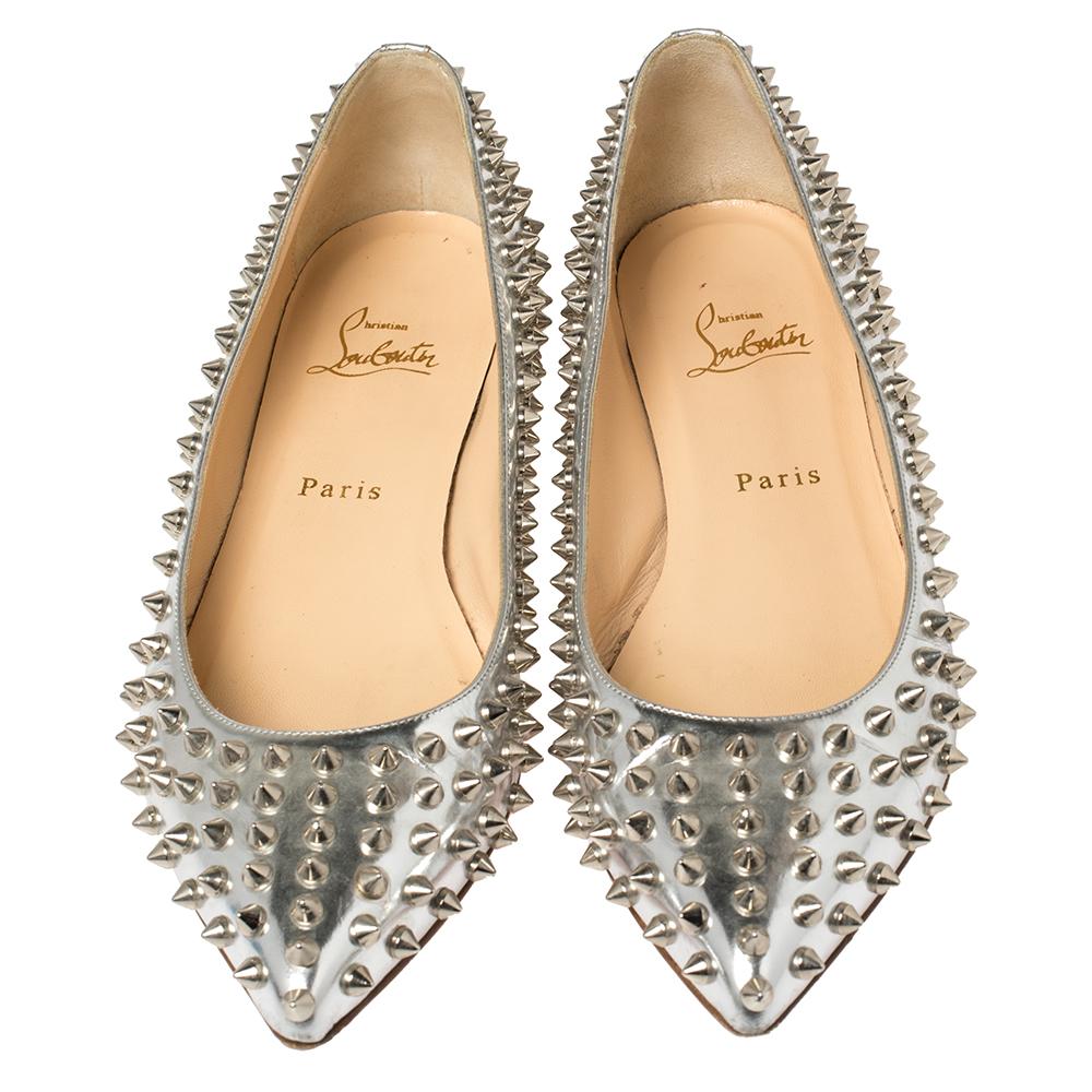 Dazzle everyone with these Louboutins by owning them today. Crafted from leather, these silver Pigalle ballet flats carry a mesmerizing shape with pointed toes. They are adorned with spike embellishments all over and finished with the signature