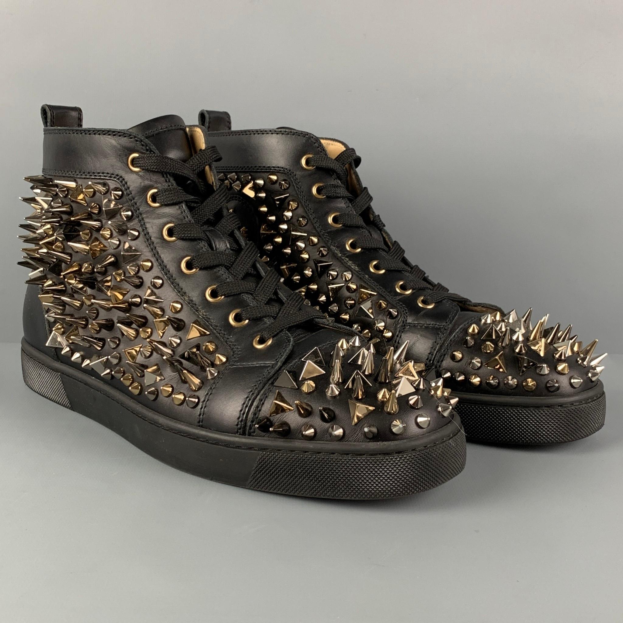 CHRISTIAN LOUBOUTIN 'Louis All Over Spikes High Top' sneakers comes in a black leather featuring silver & gold tone spike details throughout, high-top, signature red sole, and a lace up closure. Comes with dust bag. 

Very Good Pre-Owned