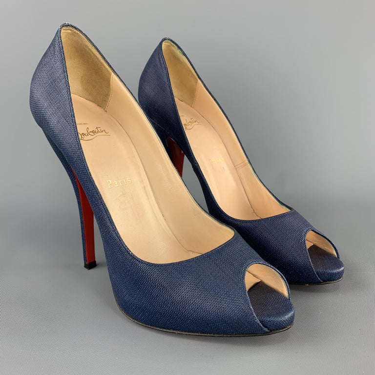 CHRISTIAN LOUBOUTIN pumps come in an indigo denim blue colored woven coated canvas material with a peep toe, hidden platform, and high covered heel. Made in Italy.

Excellent Pre-Owned Condition.
Marked: IT 40.5

Heel: 5.45 in.
Platform: 0.5 in.