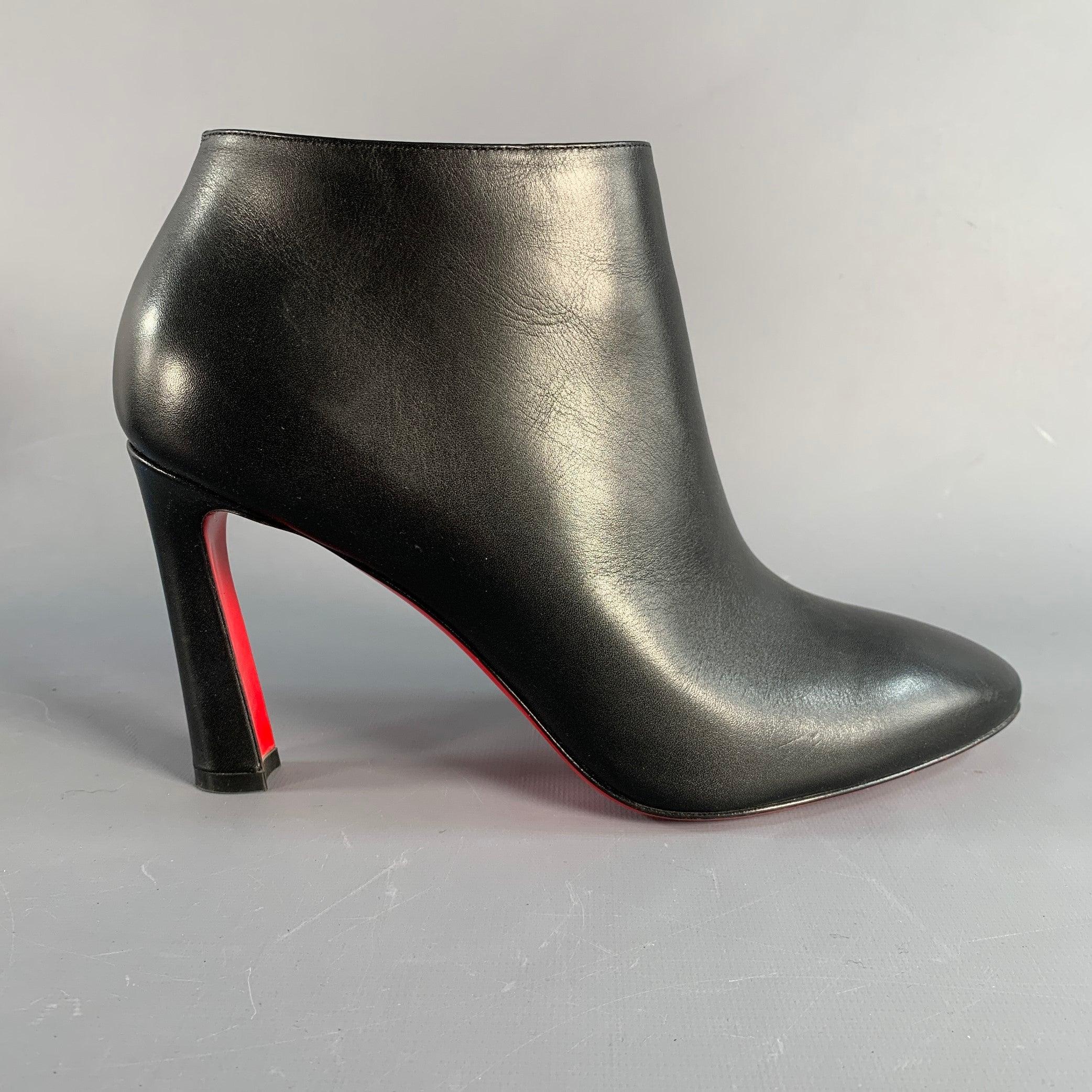 CHRISTIAN LOUBOUTIN boots in a black leather featuring an ankle bootie style and side zipper closure. Note: these soles have been professionally repainted in order to retain the integrity of the design. Made in Italy. Excellent Pre-Owned Condition.