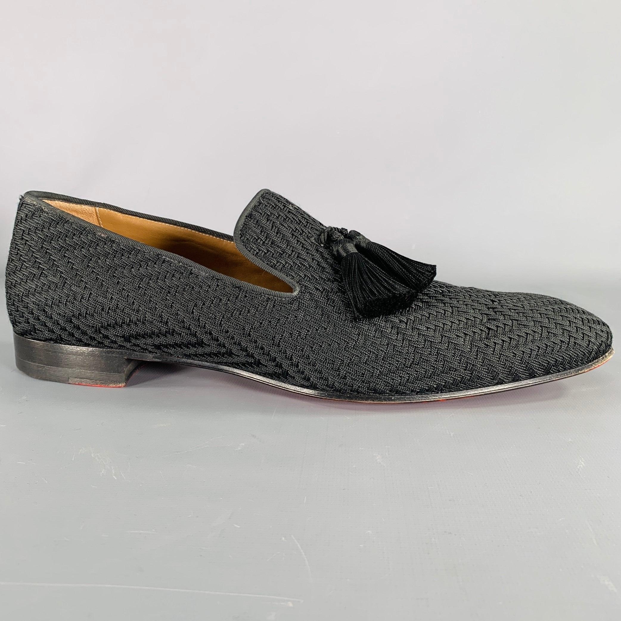 CHRISTIAN LOUBOUTIN loafers
in a black fabric featuring a woven design, tassel details, and slip on closure. Made in Italy. Note: these soles have been professionally repainted in order to retain the integrity of the design.Very Good Pre-Owned