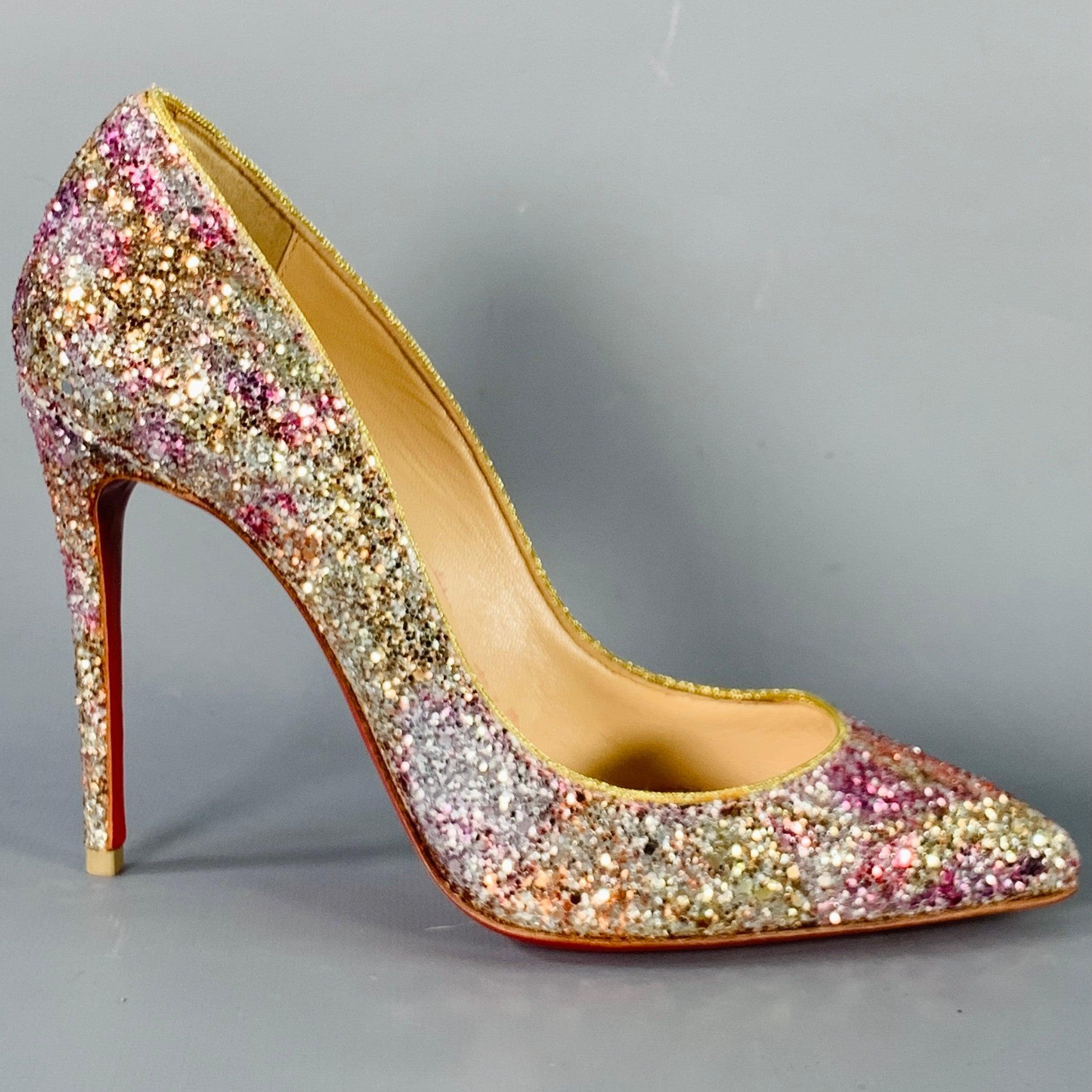 CHRISTIAN LOUBOUTIN pumps
in a silver tone and pink glitter-covered leather featuring a pointed toe, stiletto heel, and slip on closure. Note: these soles have been professionally repainted in order to retain the integrity of the design. Made in