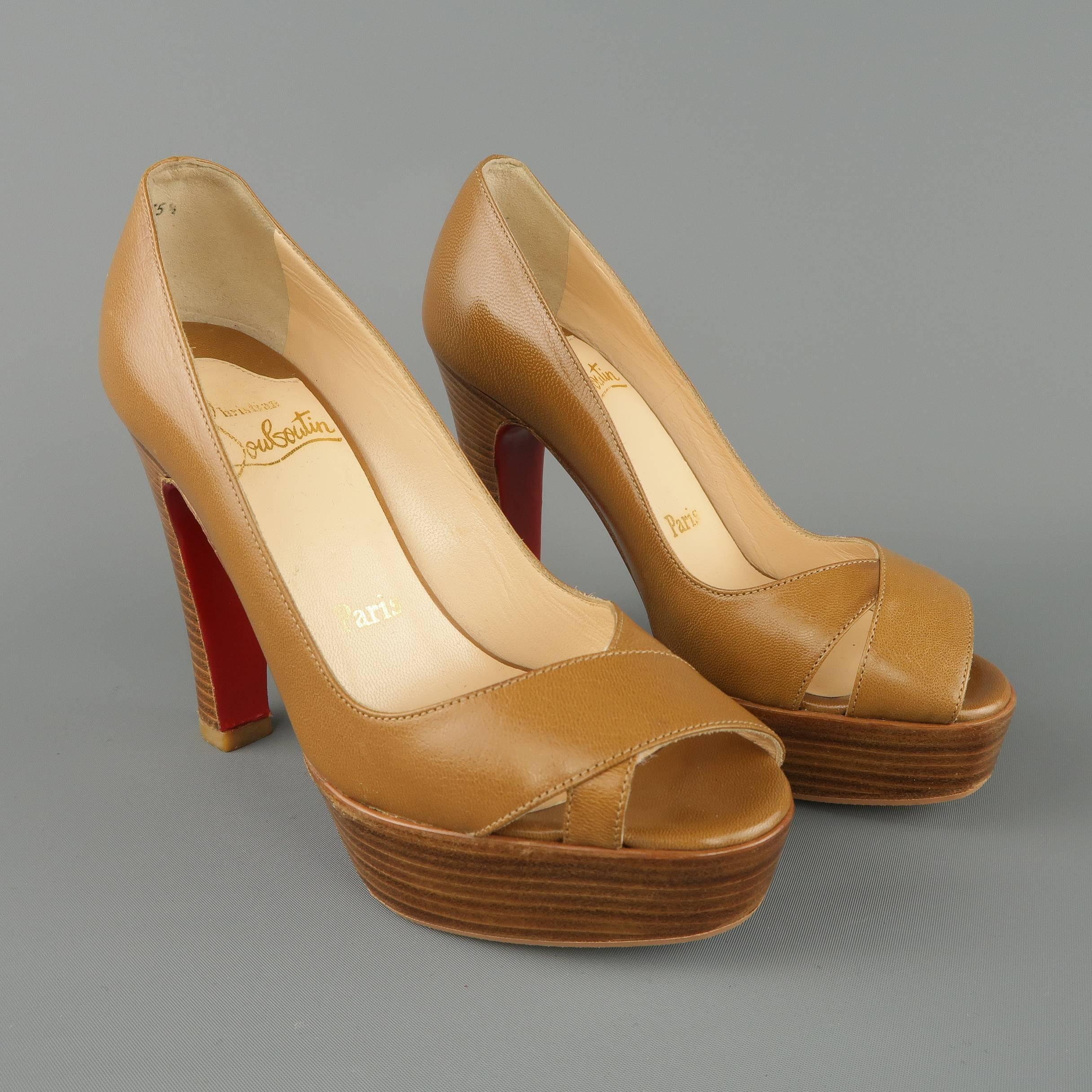 Christian Louboutin pumps come in tan leather with a wrapped peep toe and chunky stacked retro heel platform. Made in Italy.
 
Excellent Pre-Owned Condition.
Marked: IT 35.5
 
Measurements:
 
Heel: 4.45 in.
Platform: 1.25 in.
