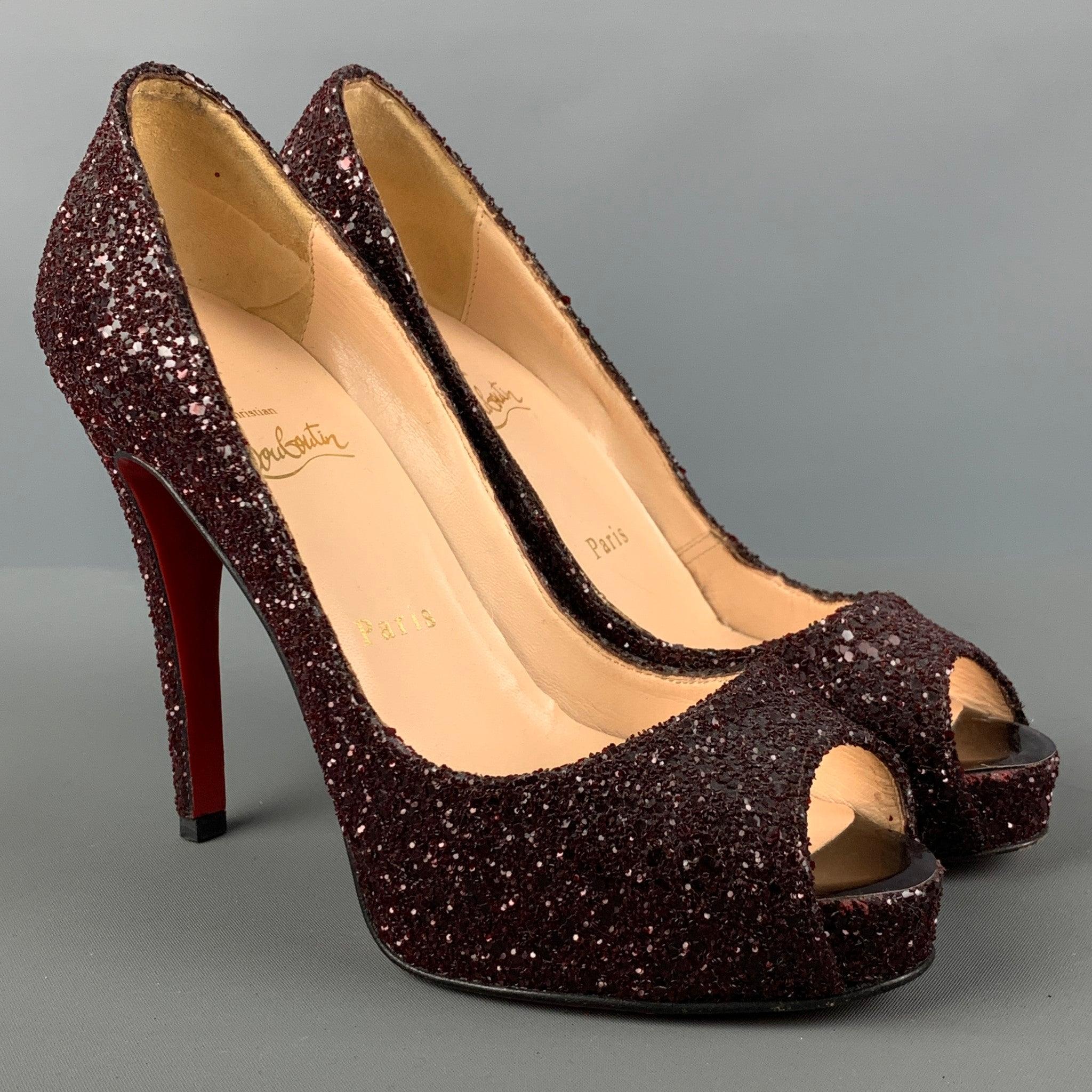 CHRISTIAN LOUBOUTIN pumps comes in a burgundy glitter material featuring an open toe, stone encrusted look, and signature red sol. Made in Italy. Very Good Pre-Owned Condition. 

Marked:   36 1/2 

Measurements: 
  Heel: 4.5 inches Platform: 0.75