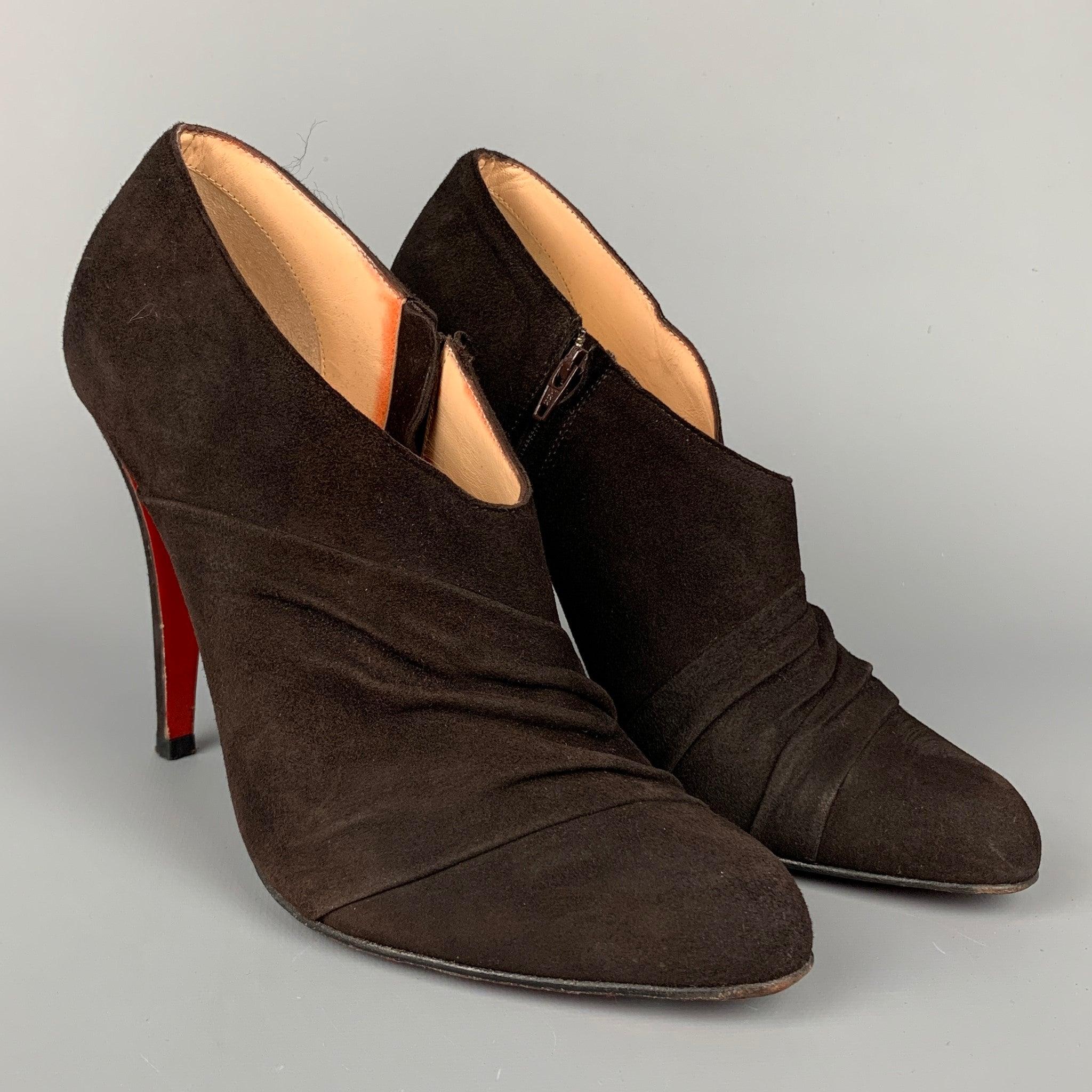 CHRISTIAN LOUBOUTIN boots comes in a dark brown suede featuring ruched design, stacked heel, side zipper closure, and signature red bottom sole. Comes with dust bag. Made in Italy.Very Good
Pre-Owned Condition. Minor wear at sole.  

Marked:   EU 37
