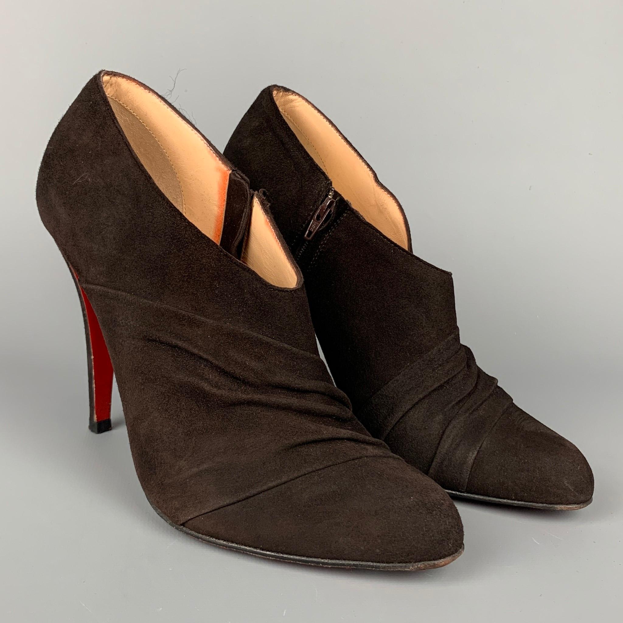 CHRISTIAN LOUBOUTIN boots comes in a dark brown suede featuring ruched design, stacked heel, side zipper closure, and signature red bottom sole. Comes with dust bag. Made in Italy.

Very Good Pre-Owned Condition. Minor wear at sole.
Marked: EU