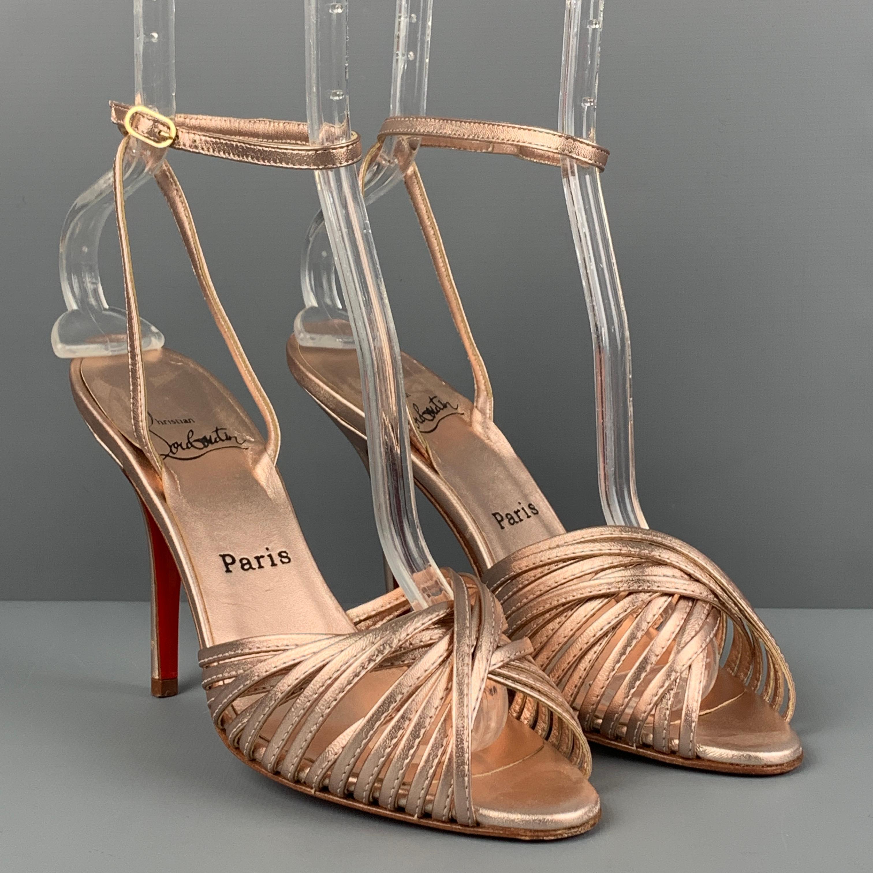 CHRISTIAN LOUBOUTIN sandals comes in a rose metallic leather featuring a open toe, ankle strap, and a stiletto heel. Made in Italy. 

Very Good Pre-Owned Condition.
Marked: 37

Measurements:

Heel: 4 in. 
