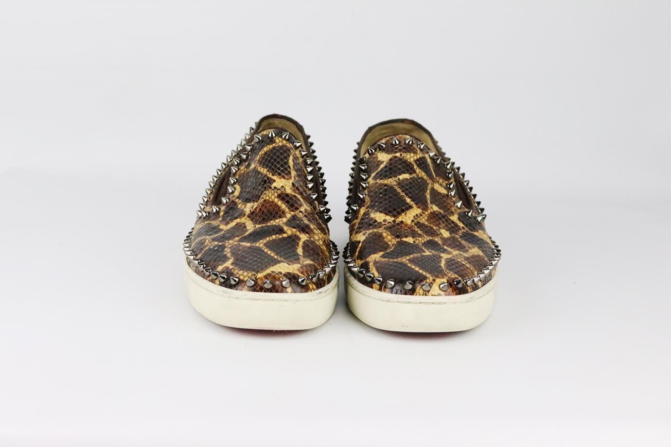 Christian Louboutin spiked python slip on sneakers. Made from brown, black and tan python with spikes in a classic slip-on sneaker style on the brand’s iconic red sole. Brown, black and tan. Slip on. Does not come with box or dustbag. Size: EU 43