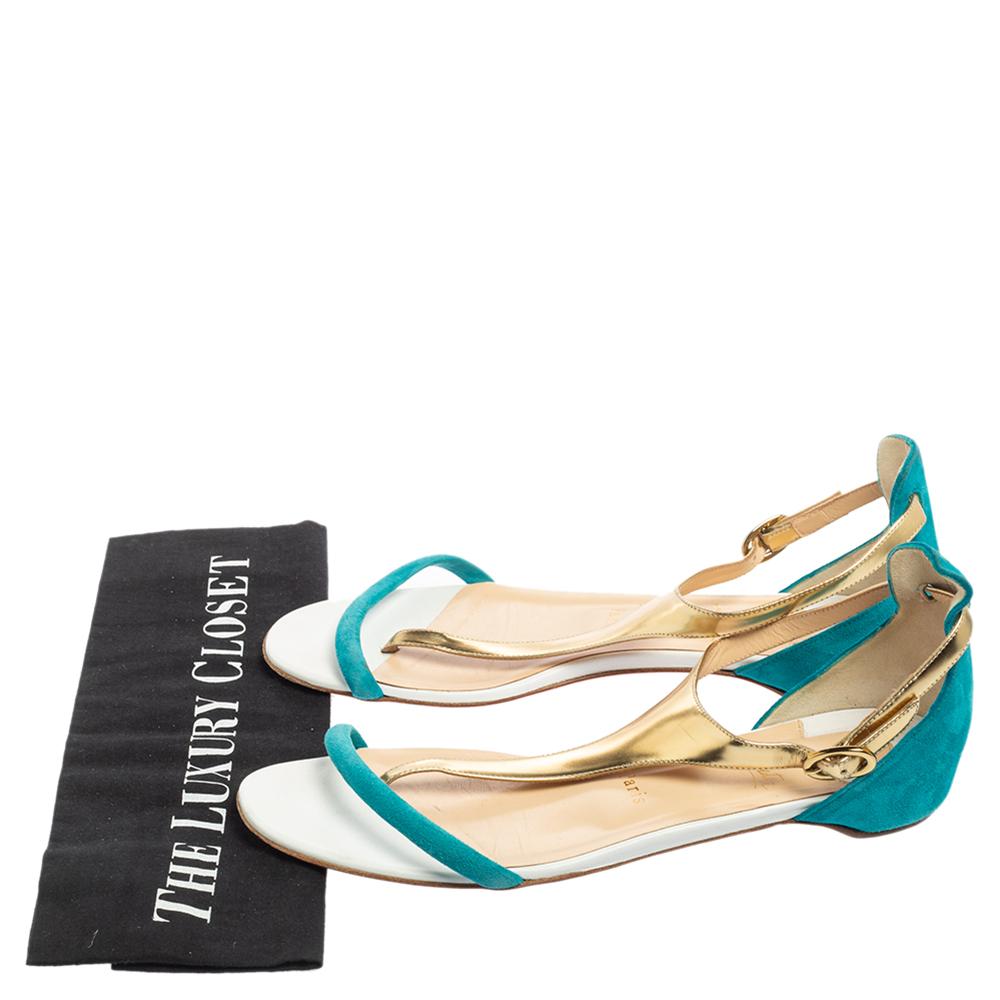 These vibrant sandals by Christian Louboutin will fit perfectly into your summer edit. They have an exterior in turquoise suede and gold leather with a simple buckle fastening at the ankles and red-coated soles for that amazing last finish.