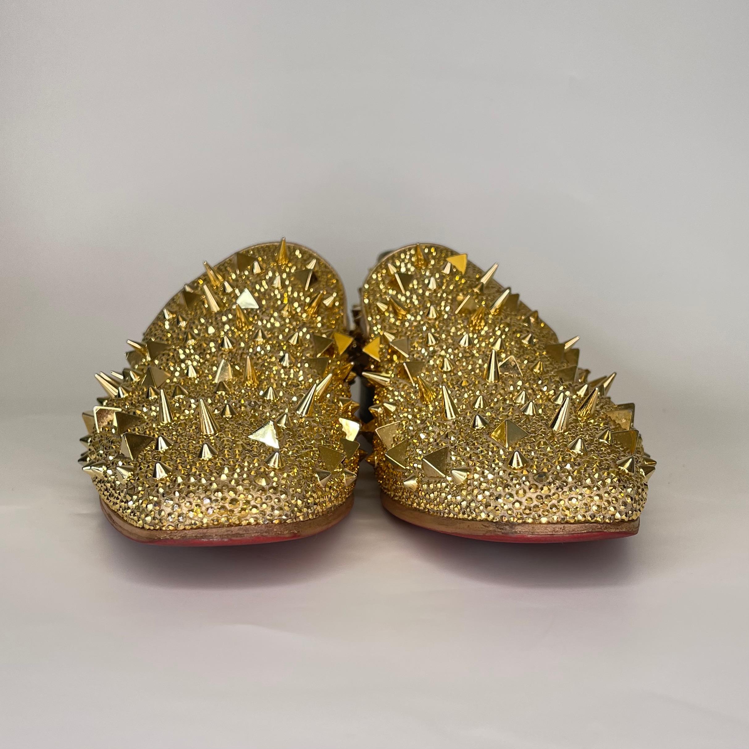 These Louboutin loafers for men are made of gold suede embellished with various shaped silver spikes all over the shoe. These shoes also feature the iconic shiny red lacquered soles. 

COLOR: Gold
MATERIAL: 
SIZE: 44 EU / 11 US
HEEL: .75”
COMES