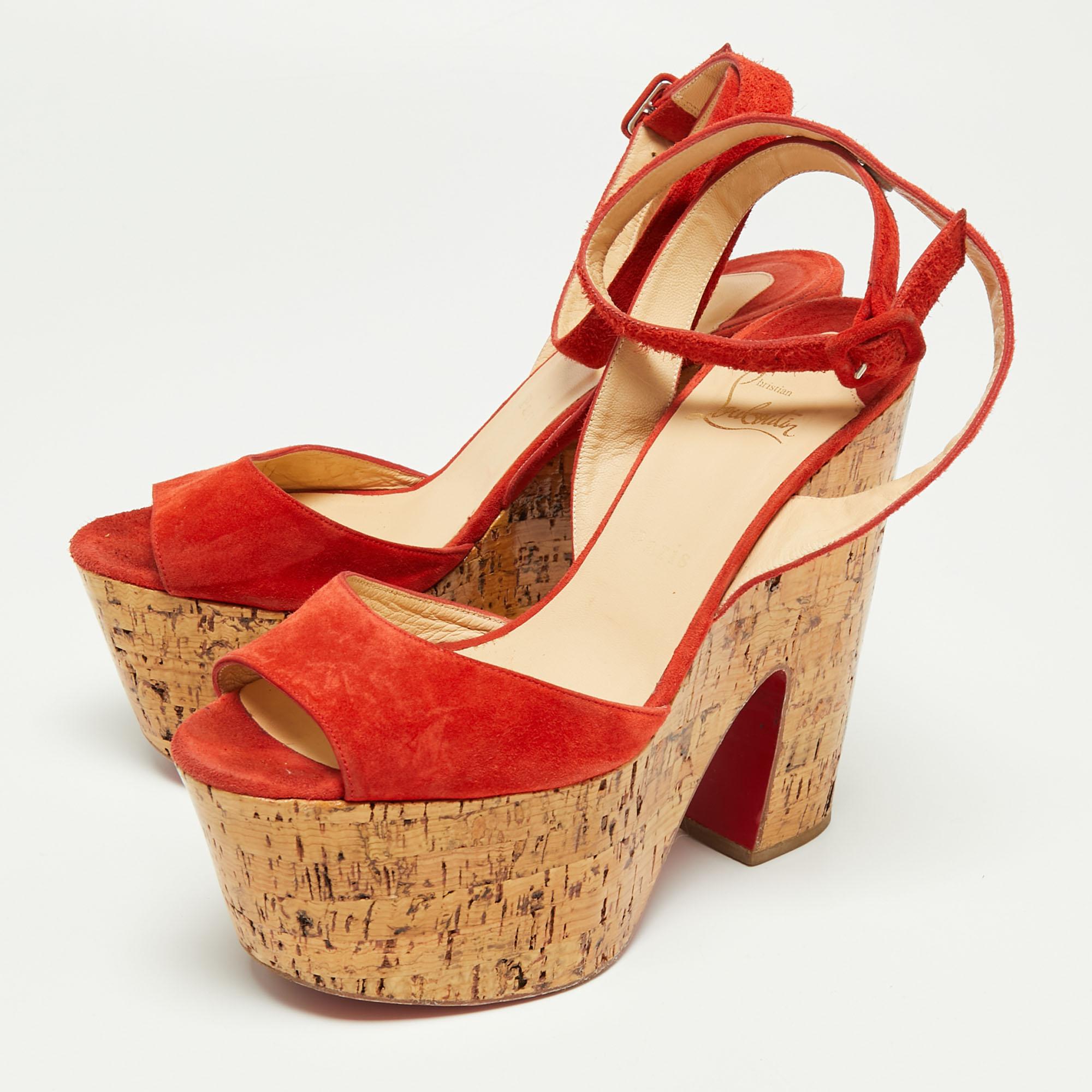 Flaunt never-ending luxury and elegance in these fabulous sandals from Christian Louboutin. They are created using red suede and showcase cork-wedge heels, open toes, and an ankle strap. Your ensemble will look chic with these CL sandals.

