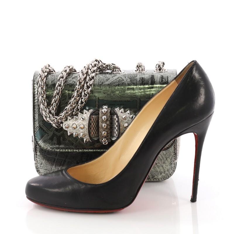 This Christian Louboutin Sweet Charity Crossbody Bag Patent Mini, crafted from green and black printed patent leather, features a long chain strap, spiked leather and mesh bow design, Louboutin sole decor, and silver-tone hardware. Its hidden