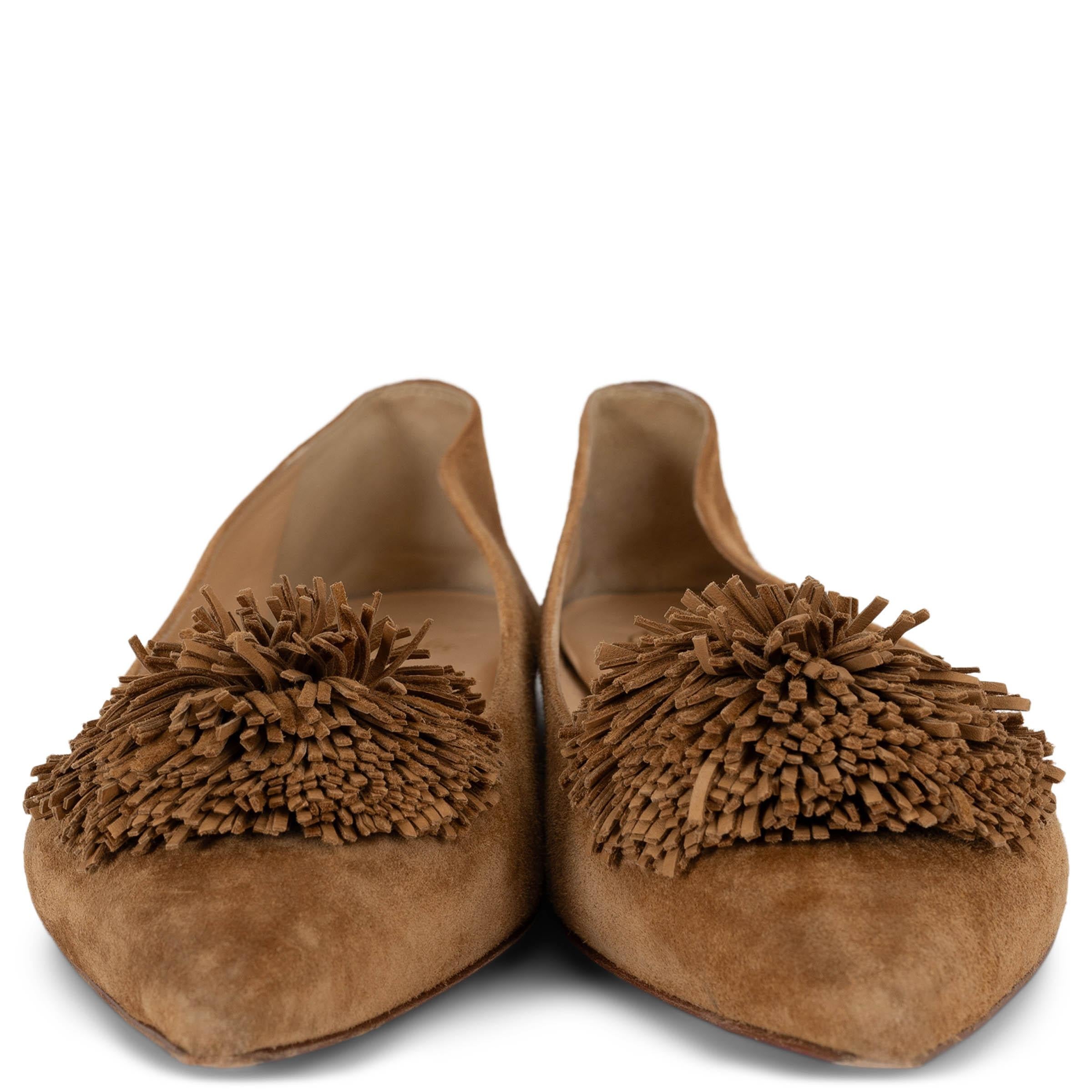 This 100% authentic Christian Louboutin Konstantina ballet flats in camel suede offer a refined take on playful elegance. Designed with pointed toes, they are adorned with a tonal pompom for a subtle yet striking detail. Finished with a small heel,