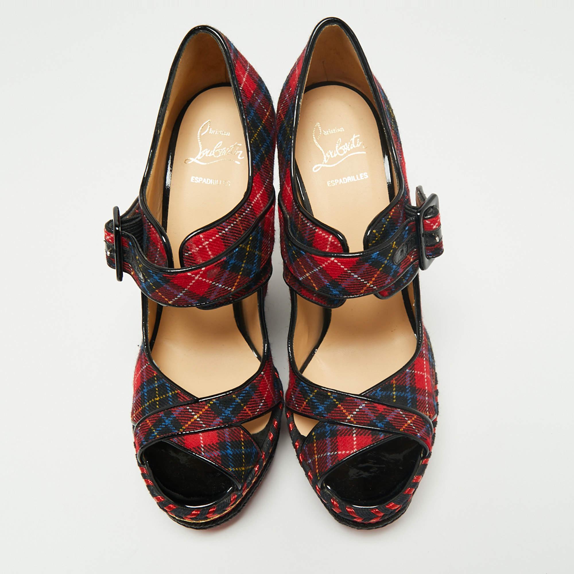 These pumps from Christian Louboutin are designed to bring comfort and style at the same time. They are made from tartan-print fabric and added with peep toes, buckled straps, leather lining, and wedge heels.

