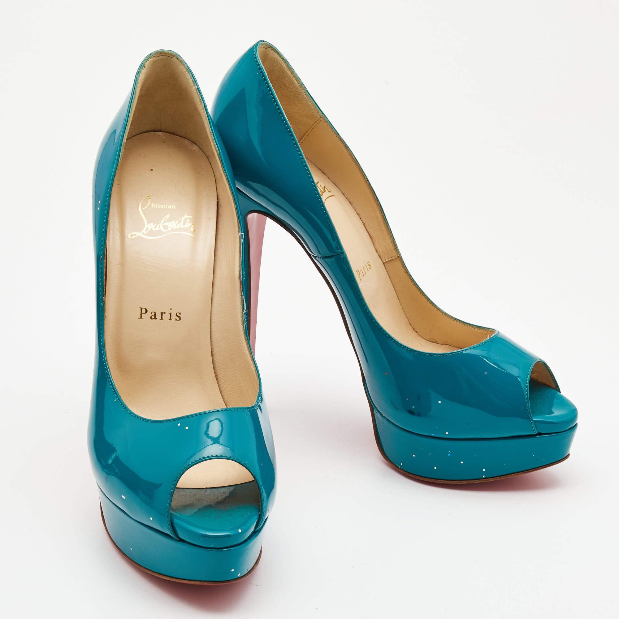 Stand out from the crowd with this classy pair of Louboutins that exude high fashion with class. Crafted from patent leather, this is a creation from their Lady Peep collection. It features a teal green shade with peep toes and a glossy exterior.