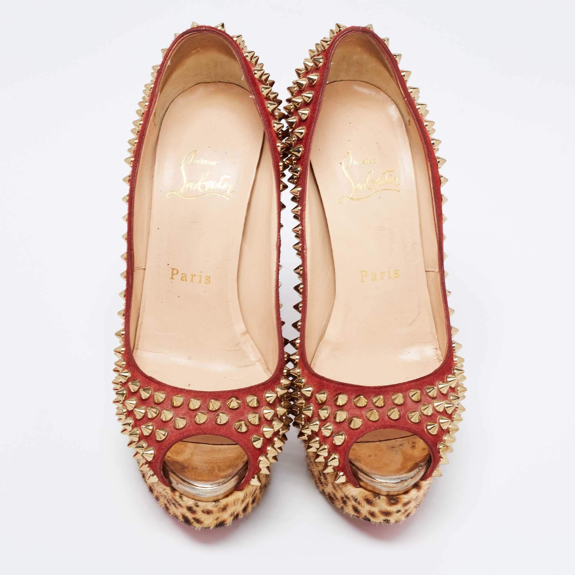 Add a statement finish with these Louboutins. Crafted from suede and leather, these Lady Peep spikes pumps carry eye-catching decorations, peep toes, and 12 cm heels with platforms covered in leopard-print calf hair. Complete with the signature red
