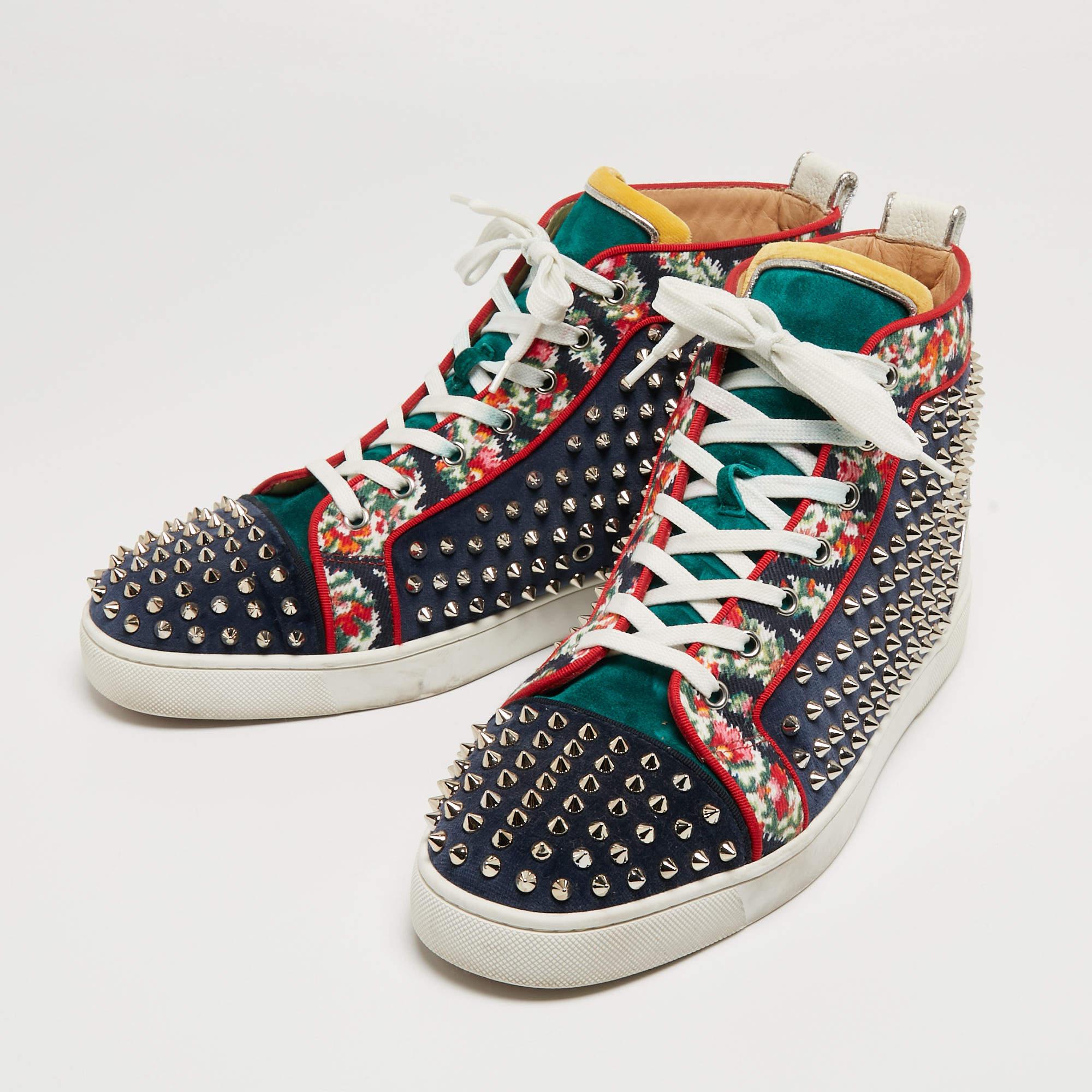 These Christian Louboutin's Louis sneakers are designed in a tricolor leather body with fabric panels and feature trendy spikes detail all over for a bold look. Set on a rubber sole, this pair features contrasting lace-ups and comfortable insoles